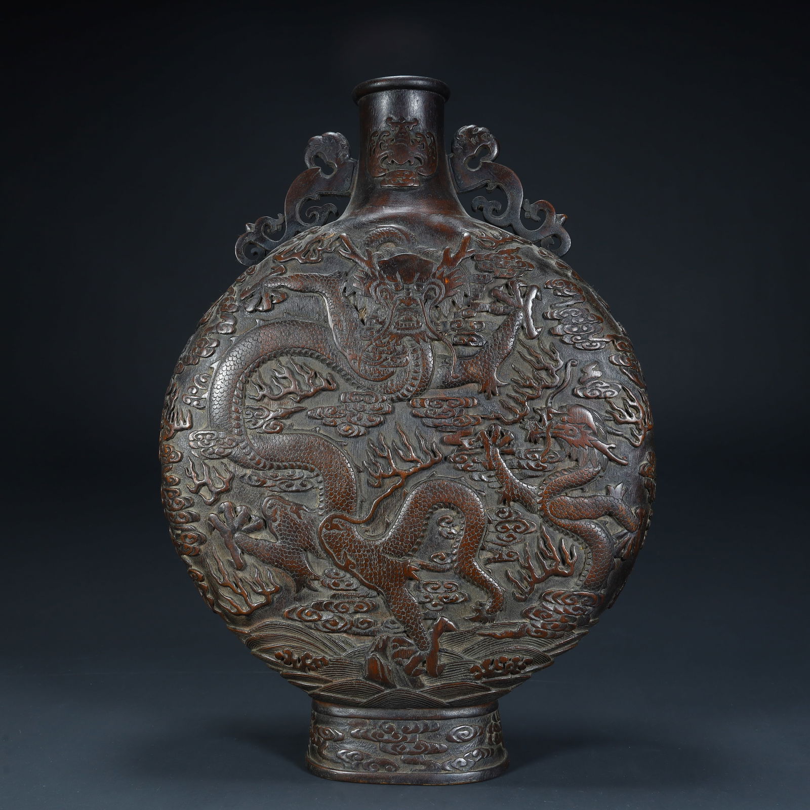 A Qing Dynasty agarwood carved cloud dragon pattern flat bottle: Qing Dynasty agarwood carved cloud dragon pattern flat bottle SIZE: H:38cm L:27cm W:8cm W:1096g