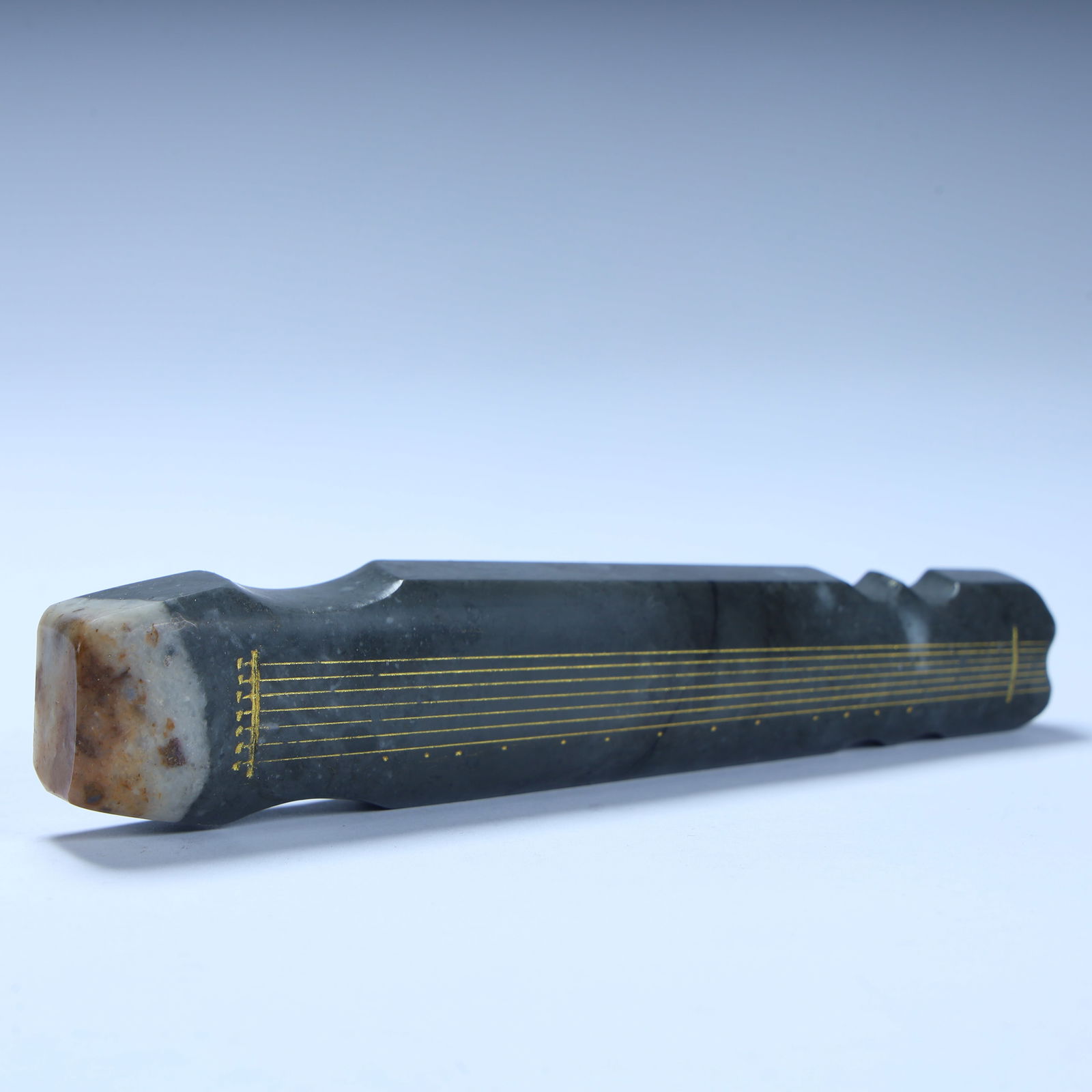 A Qing Dynasty jade guqin-shaped study utensil: Qing Dynasty jade guqin-shaped study utensils SIZE: H:1.5cm L:12.5cm W:2.7cm W:97.5g