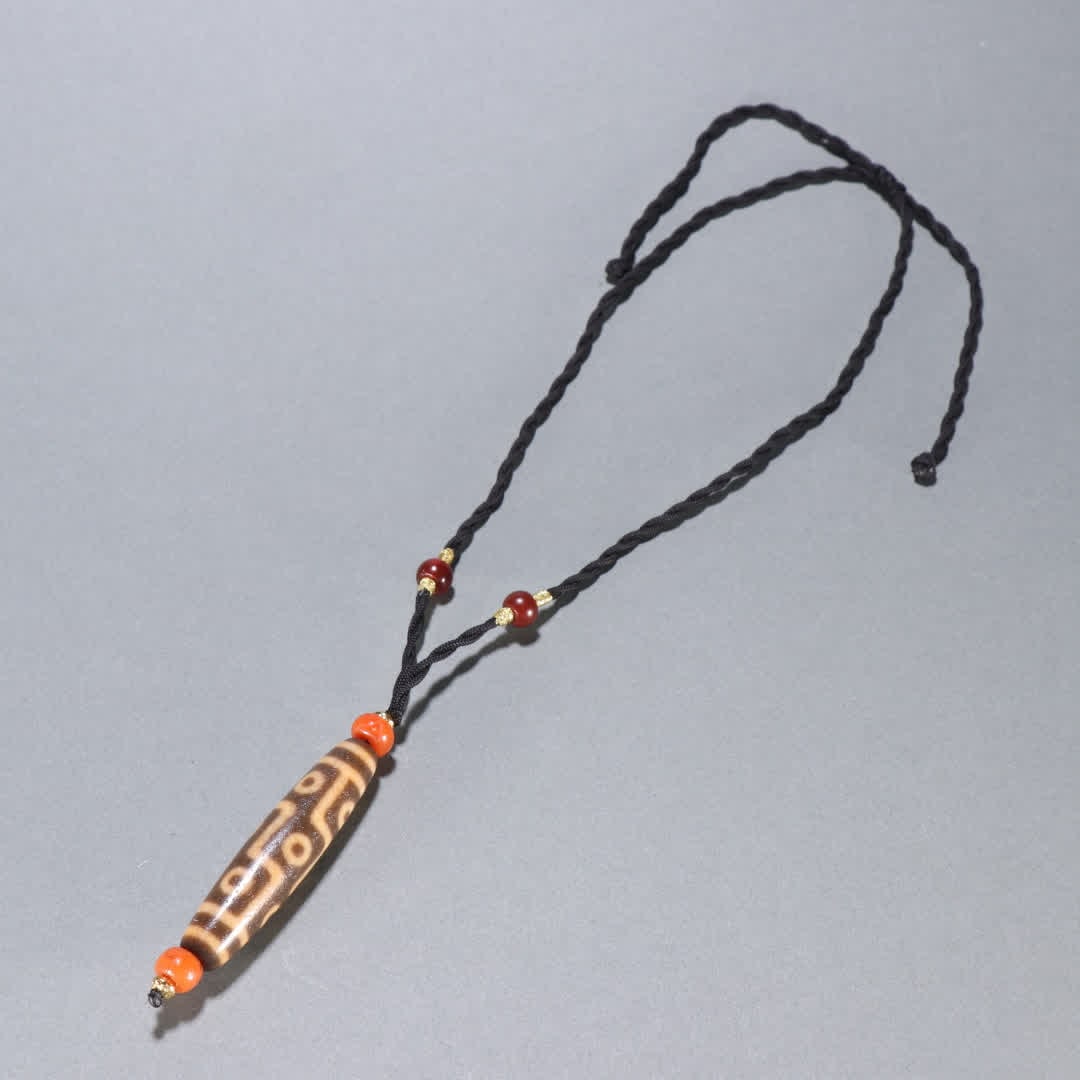 A Qing Dynasty nine-eyed Dzi pendant (1 of 9)