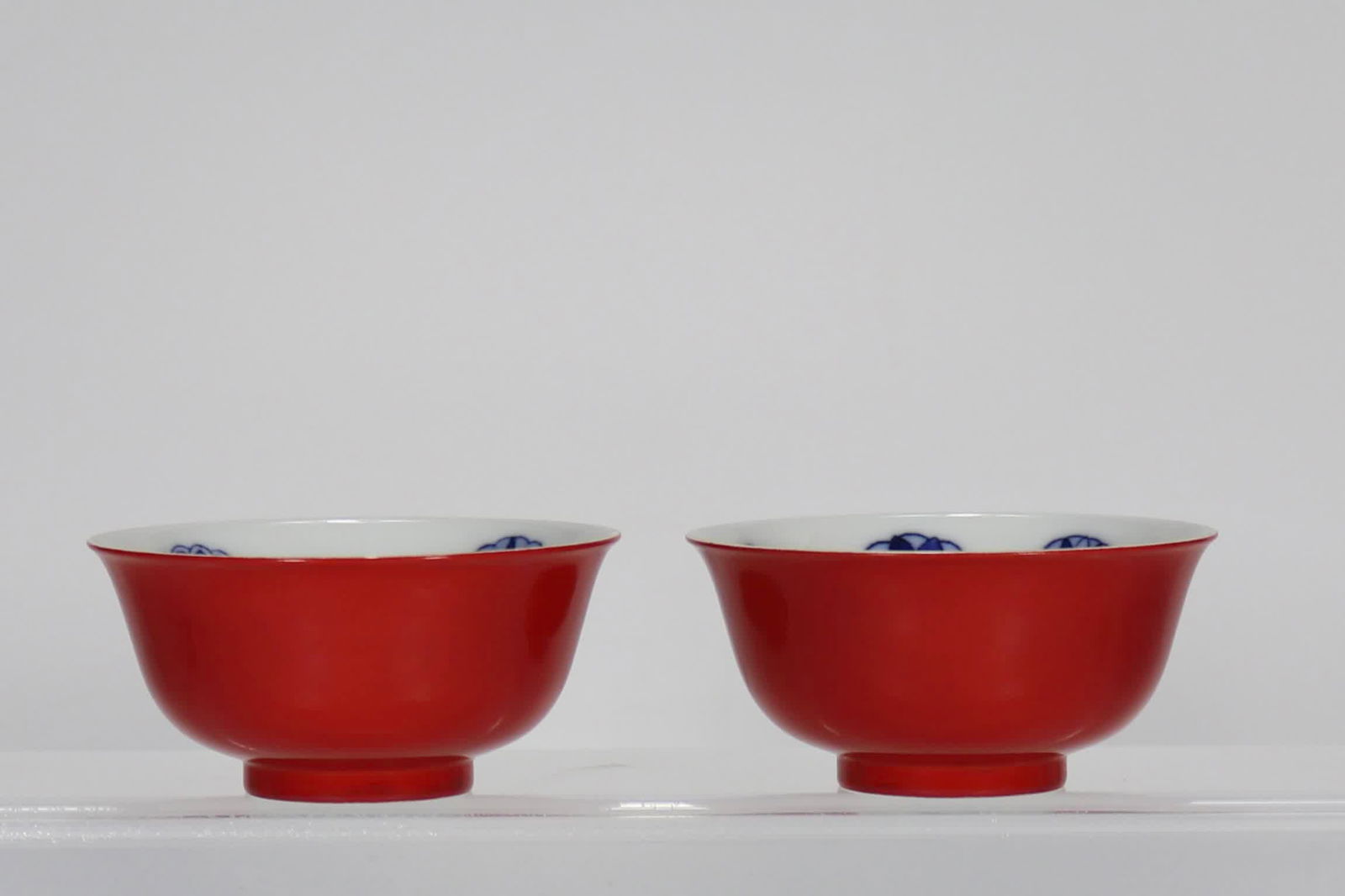 A pair of small bowls of blue and white hops in the red glaze of chili peppers made in the Qing (1 of 9)