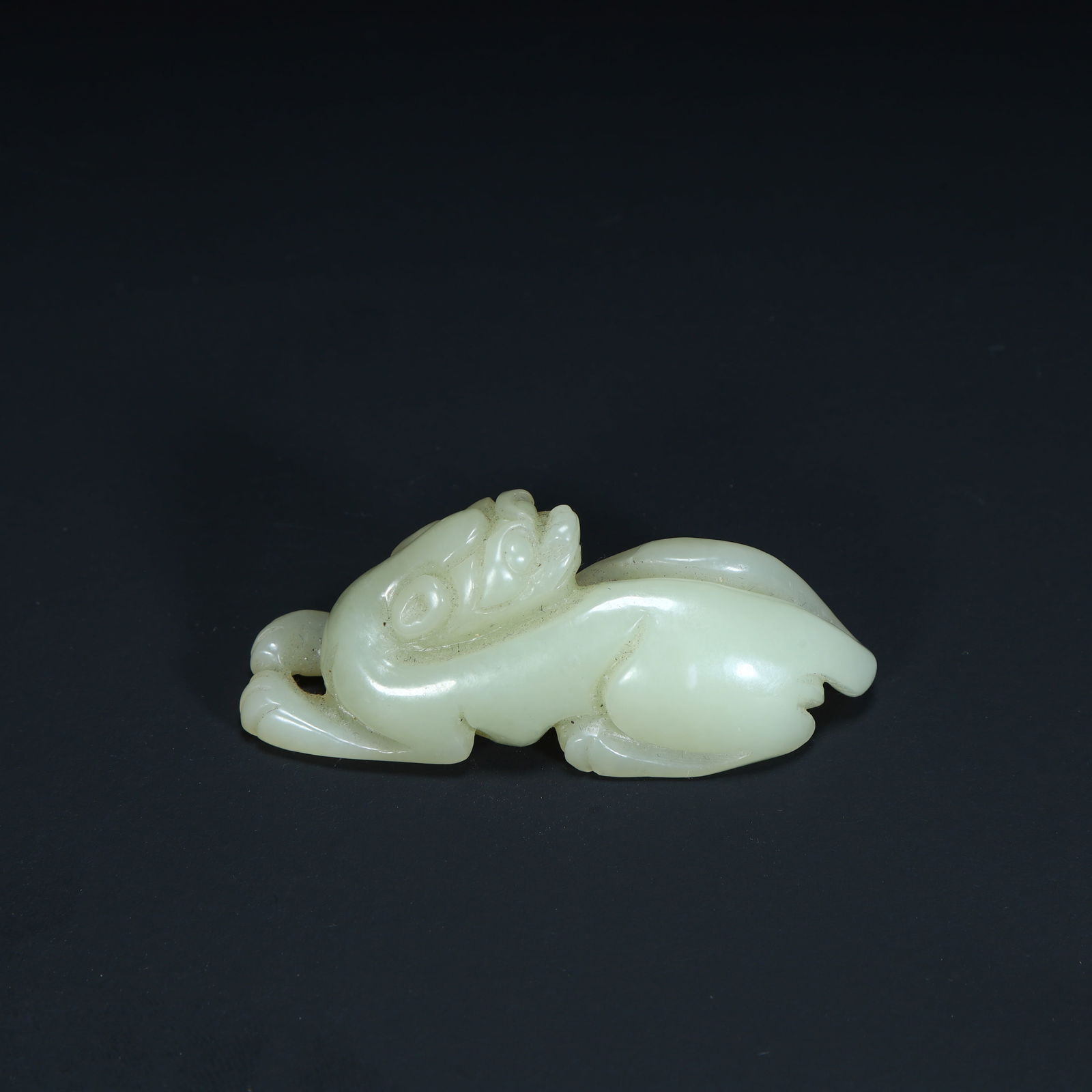 A piece of Qing Dynasty Hetian jade auspicious beast (Pixiu). (1 of 9)