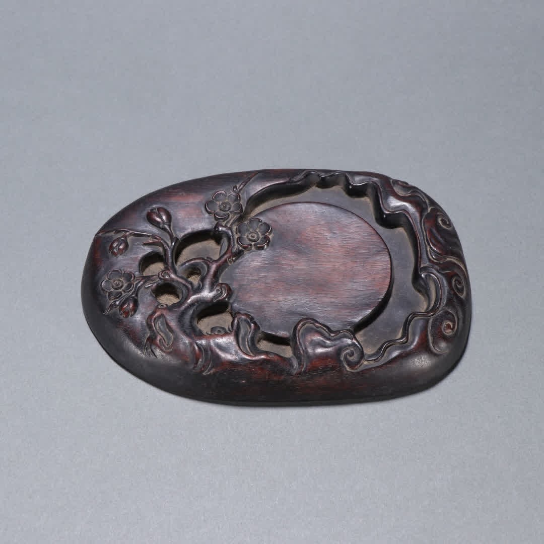 A Qing Dynasty rosewood plum pattern inkstone (1 of 9)