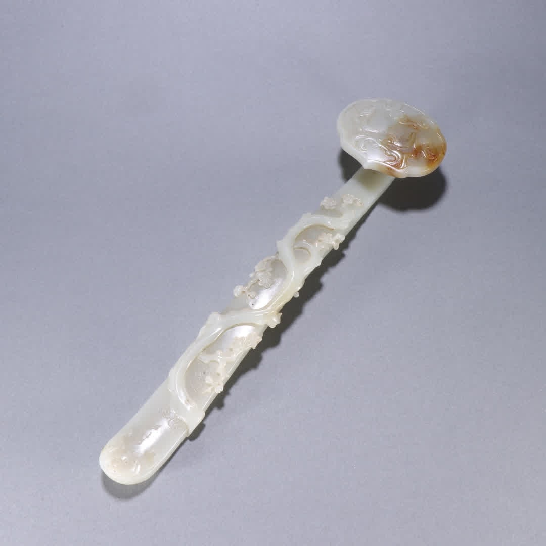 A Qing Dynasty Hetian jade longevity peach plum pattern ruyi handle (1 of 9)