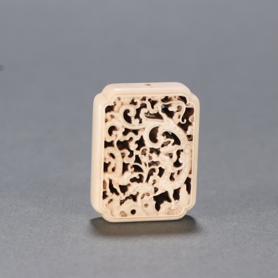 A Qing Dynasty ivory carved dragon pattern back cloud (1 of 8)