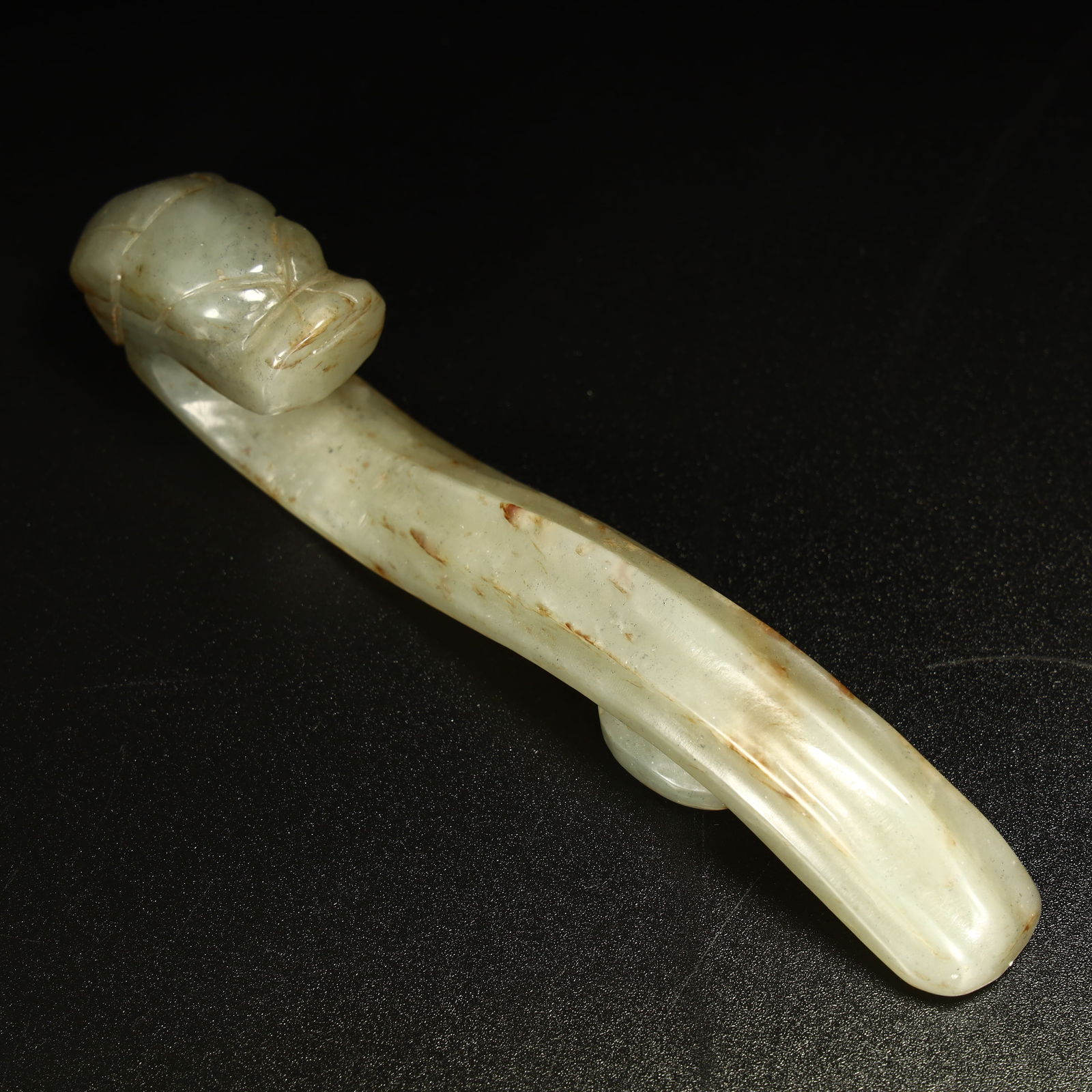 A jade dragon head with a hook