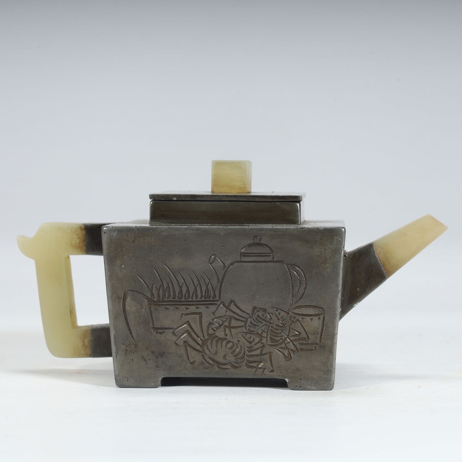 A Qing Dynasty tin-inlaid jade poetry teapot: Qing Dynasty tin-inlaid jade poetry teapot SIZE: H:7.5cm L:15.5cm W:8.5cm W:753g (The Dimensions Of All Batches Are Manually Measured.If You Need More Detailed Information, Please Contact Our Customer