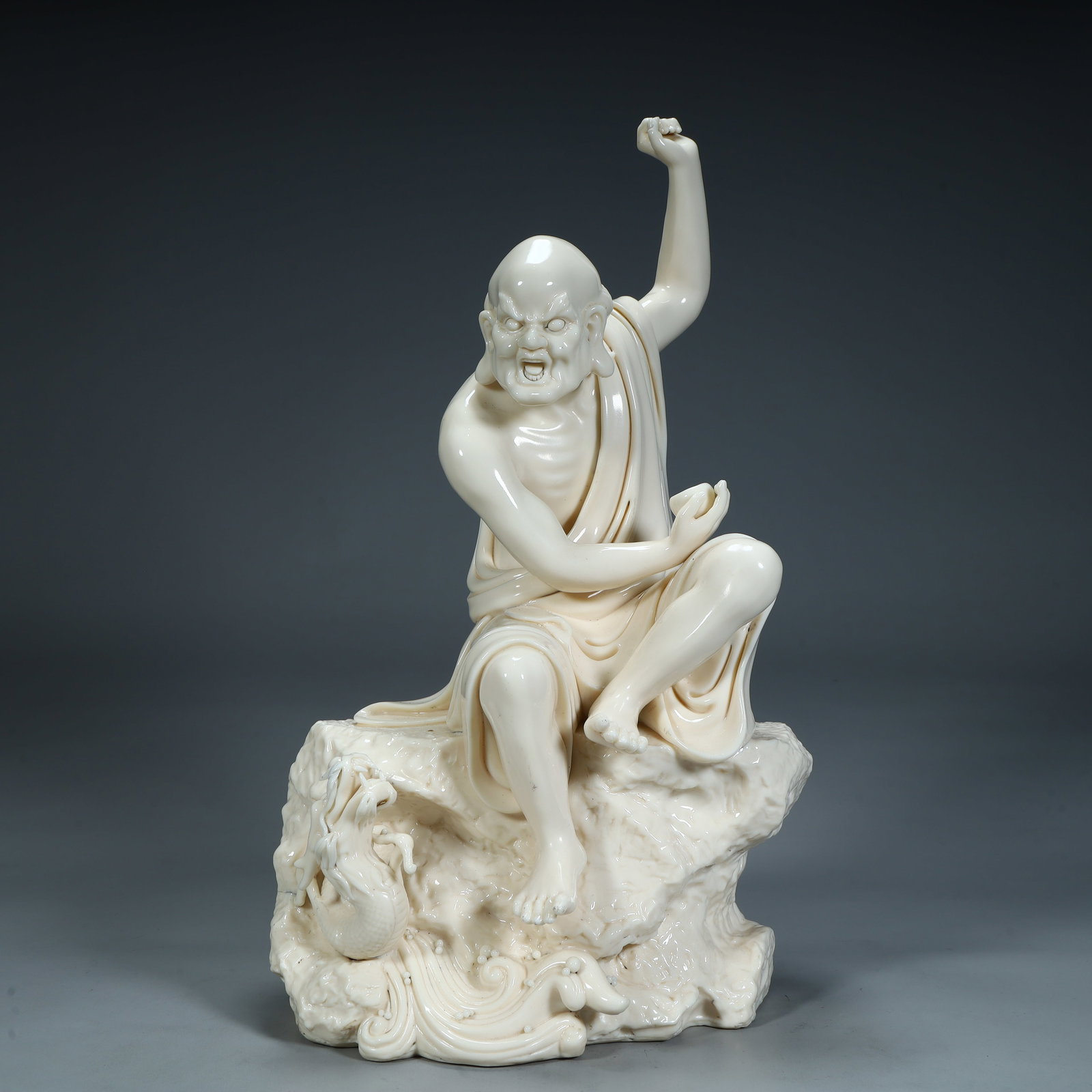 A Qing Dynasty Dehua white porcelain dragon descending Arhat ornament: Qing Dynasty Dehua white porcelain dragon descending Arhat ornament SIZE: H:37cm L:21cm W:16cm W:4.1kg (The Dimensions Of All Batches Are Manually Measured.If You Need More Detailed Information, Pleas