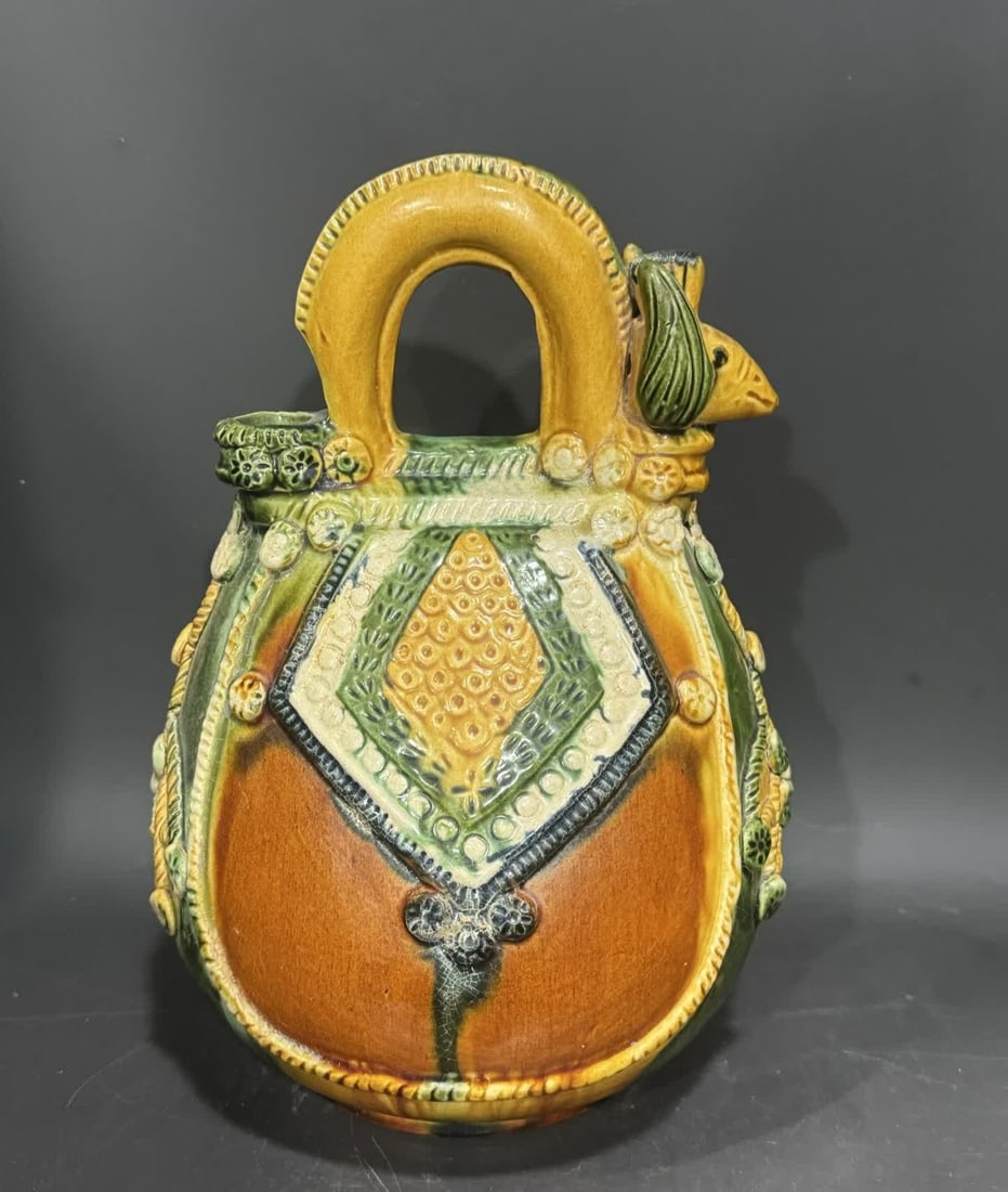 A Tang Dynasty three-color cockscomb pot: Tang Dynasty three-color cockscomb pot SIZE: H:26cm W:17cm (The Dimensions Of All Batches Are Manually Measured.If You Need More Detailed Information, Please Contact Our Customer Service Before Biddin