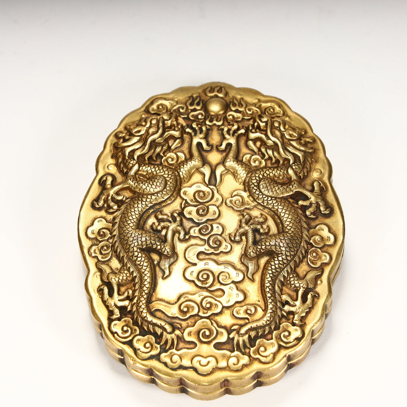 A piece of copper gilt, embossed with double dragon bead pattern on the box surface, surrounded by: Copper gilded, embossed double dragon bead pattern on the box surface, surrounded by cloud pattern decoration, delicate craftsmanship, and the shape and decoration have a typical Qing Dynasty style,