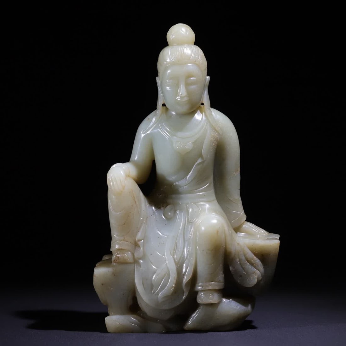 A Qing Dynasty green jade free Guanyin Shanzi study offering: This statue of Guanyin is carved from Hetian green jade The jade is glossy, the color is pale blue, the whole body is soft and precious light, and the part has natural yellowish-brown spots, Guanyin i