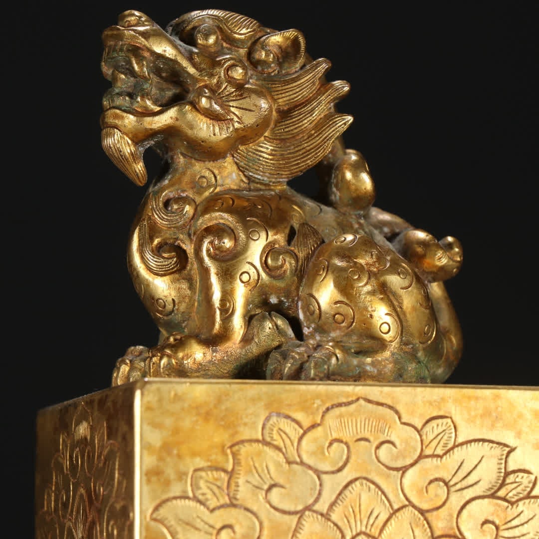 A copper gilt beast button seal - 2