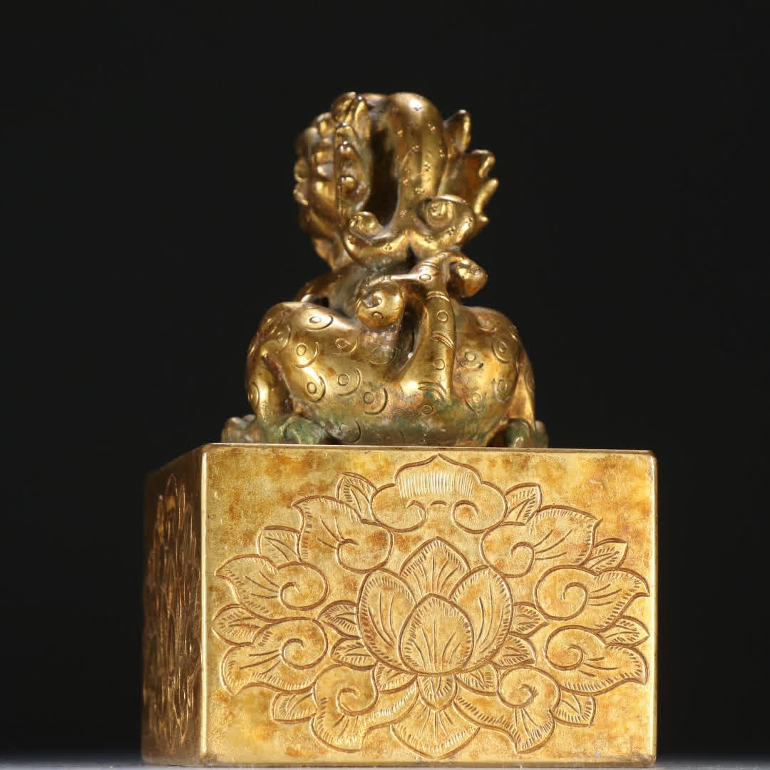 A copper gilt beast button seal - 3