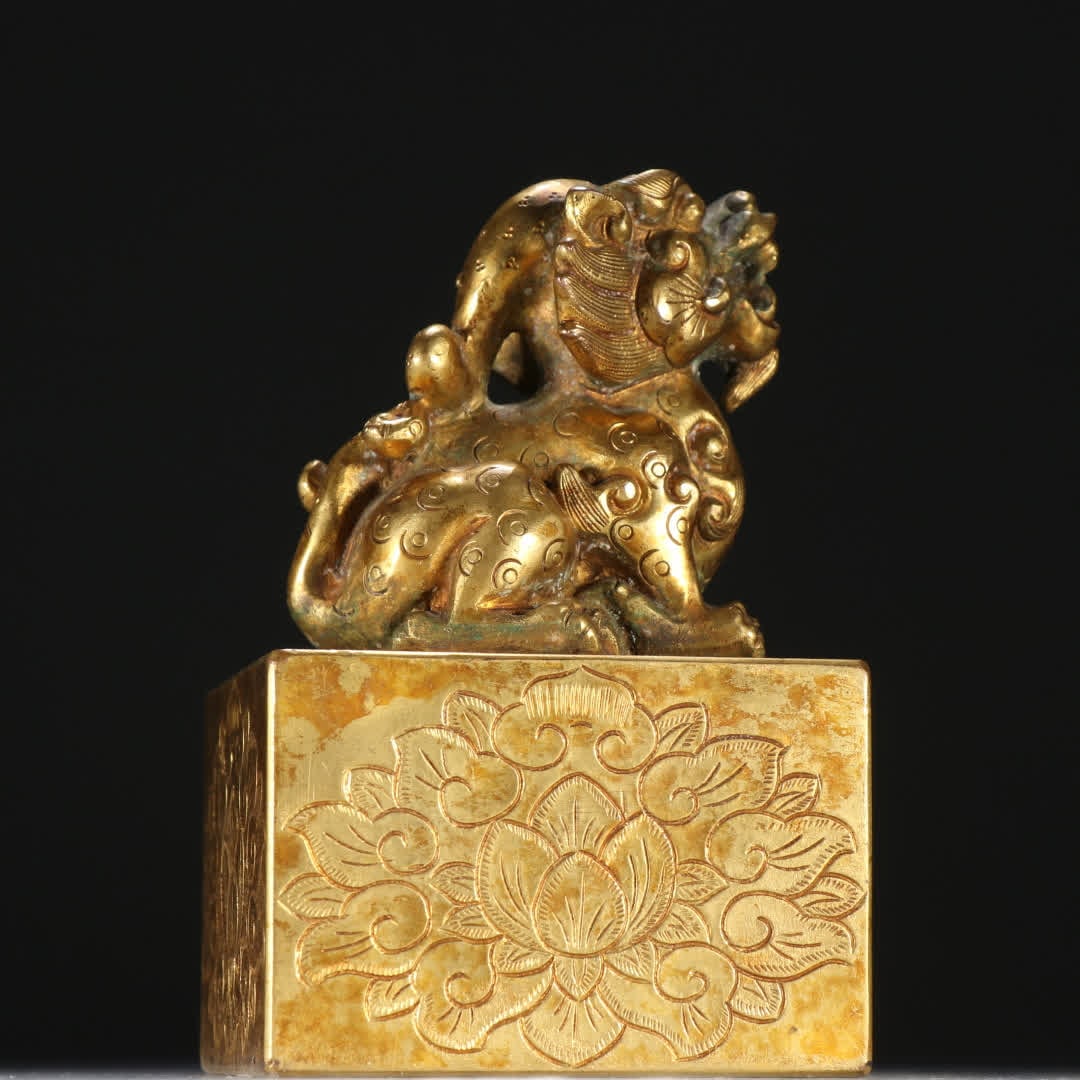 A copper gilt beast button seal - 5