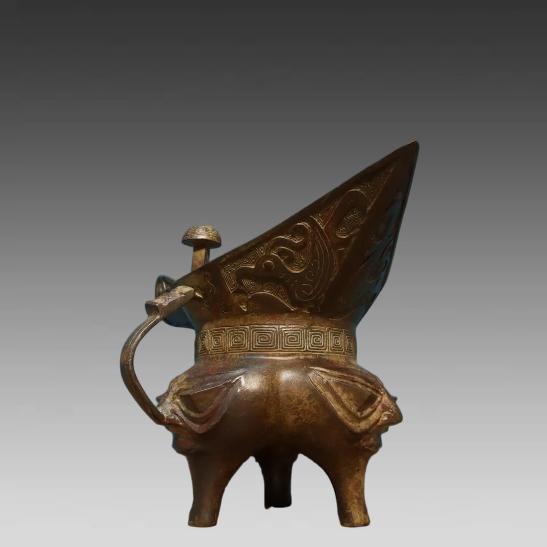 A bronze human face corner cup - 8