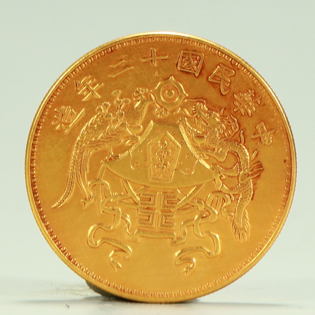 A silver gilt coin of the twelfth year of the Republic of China: In the twelfth year of the Republic of China, the dragon and phoenix were silver gilded coins SIZE: D:3.9cm W:37.7g (The Dimensions Of All Batches Are Manually Measured.If You Need More Detailed Infor