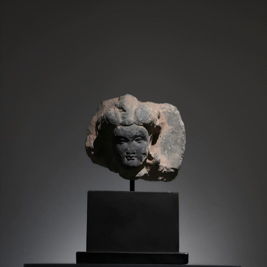 A Gandhara stone carved head of a Bodhisattva from the 2nd to 5th centuries AD: Gandhara stone carved head statue of Bodhisattva SIZE: W: 11cm H: 10cm with base cm H: 18cm (The Dimensions Of All Batches Are Manually Measured.If You Need More Detailed Information, Please Contact O