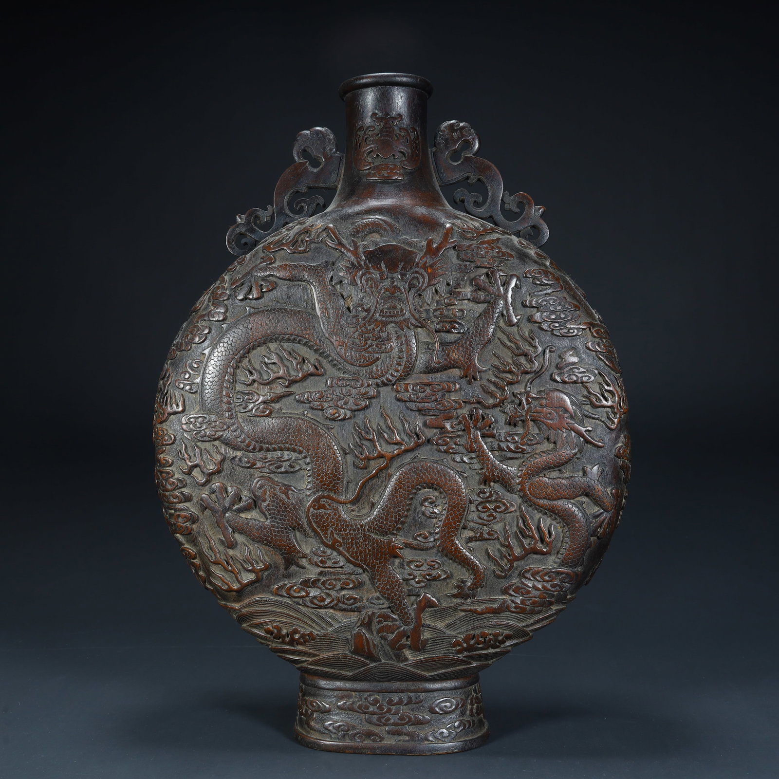 A Qing Dynasty agarwood carved cloud dragon pattern flat bottle (1 of 13)