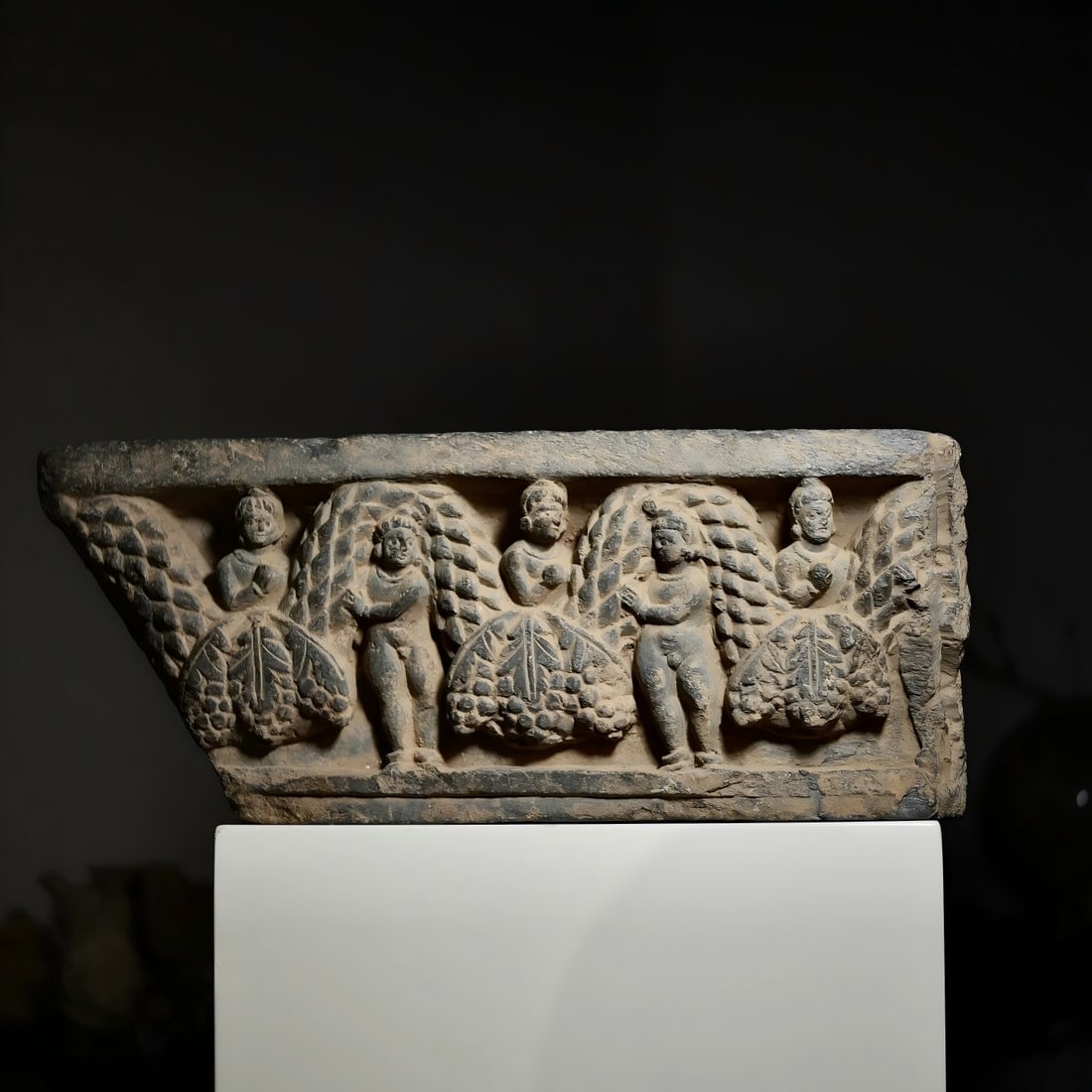A Gandhara stone sculpture from the 2nd to 5th centuries AD carrying a flower vine boy: Gandhara stone carving carrying a flower vine boy SIZE: W: 38cm H: 16cm T: degree 5cm (The Dimensions Of All Batches Are Manually Measured.If You Need More Detailed Information, Please Contact Our Cus