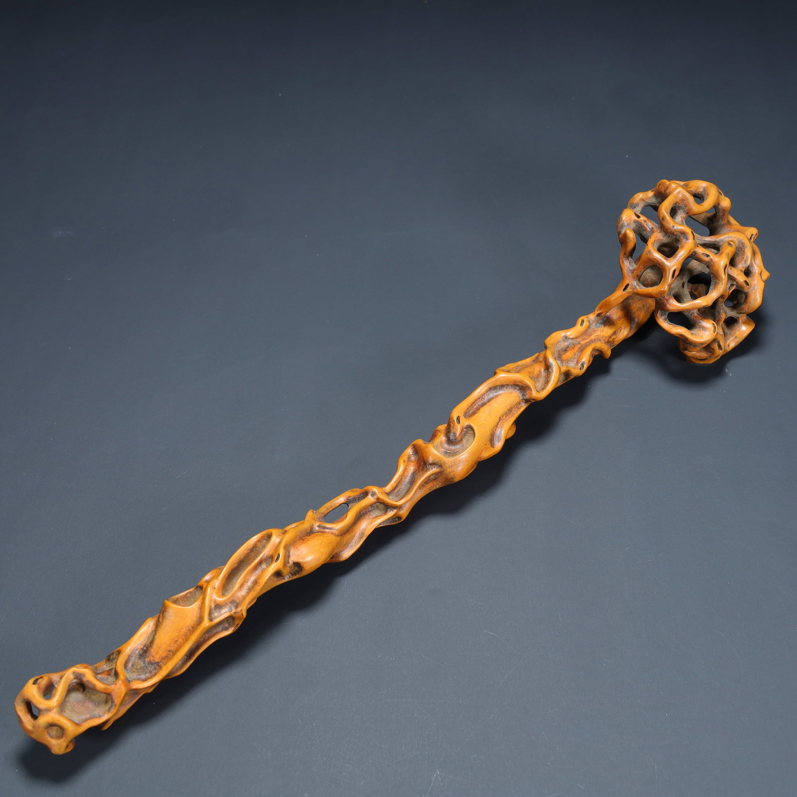 A Qing Dynasty boxwood imitation "Taihu Lake Stone" ruyi: Qing Dynasty boxwood imitation "Taihu Lake Stone" ruyi SIZE: L:32cm W:7cm W:67.7g (The Dimensions Of All Batches Are Manually Measured.If You Need More Detailed Information, Please Contact Our Custome
