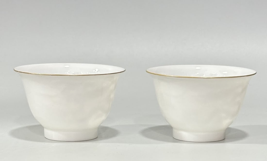 A thin-bodied cup from the Qing Yongzheng period, with sweet white glaze carved with double dragons: Qing Dynasty Yongzheng Sweet White Thin-bodied Cup with Double Dragons Playing with Pearls Inside SIZE: H:4.5cm mouthD:7.5cm (The Dimensions Of All Batches Are Manually Measured.If You Need More Detai