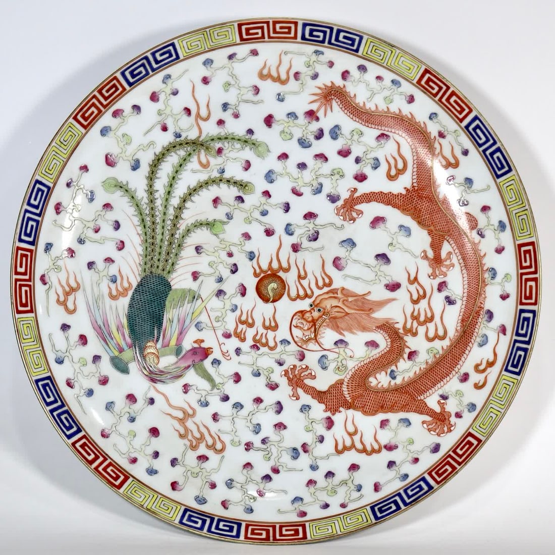 A famille rose plate with dragon and phoenix playing with pearls, made during the Guangxu period of: A famille rose appreciation plate with dragon and phoenix playing with pearls, made during the Guangxu period of the Qing dynasty SIZE: H:7.8cm Mouth 47cm (The Dimensions Of All Batches Are Manually M