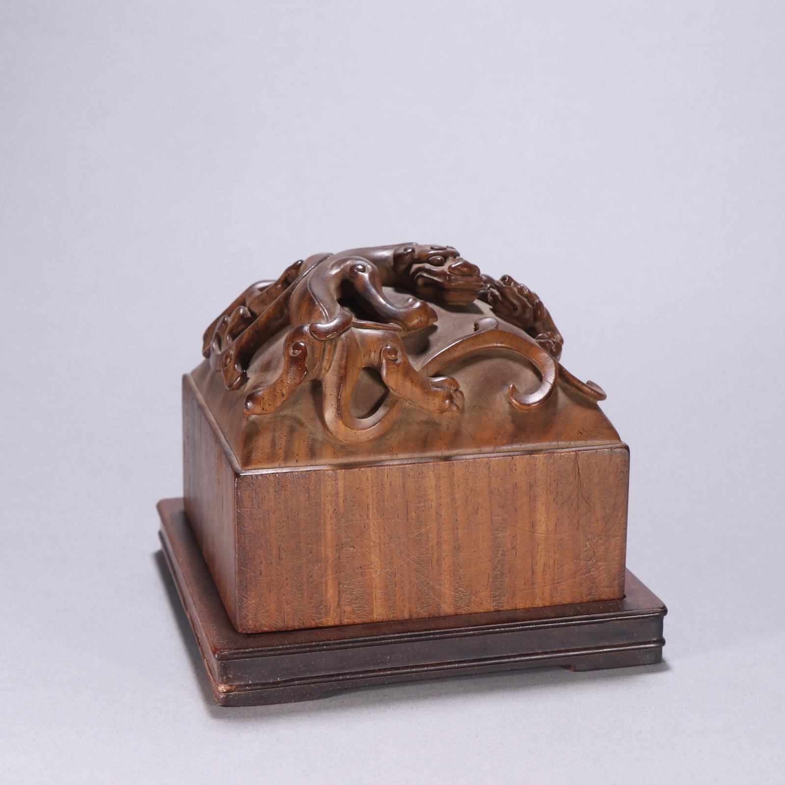 A Qing dynasty huanghuali chi dragon knob seal: Qing Dynasty Huanghuali Chilong Knob Seal SIZE: H:10cm W:11.3cm W:846.6g (The Dimensions Of All Batches Are Manually Measured.If You Need More Detailed Information, Please Contact Our Customer Service