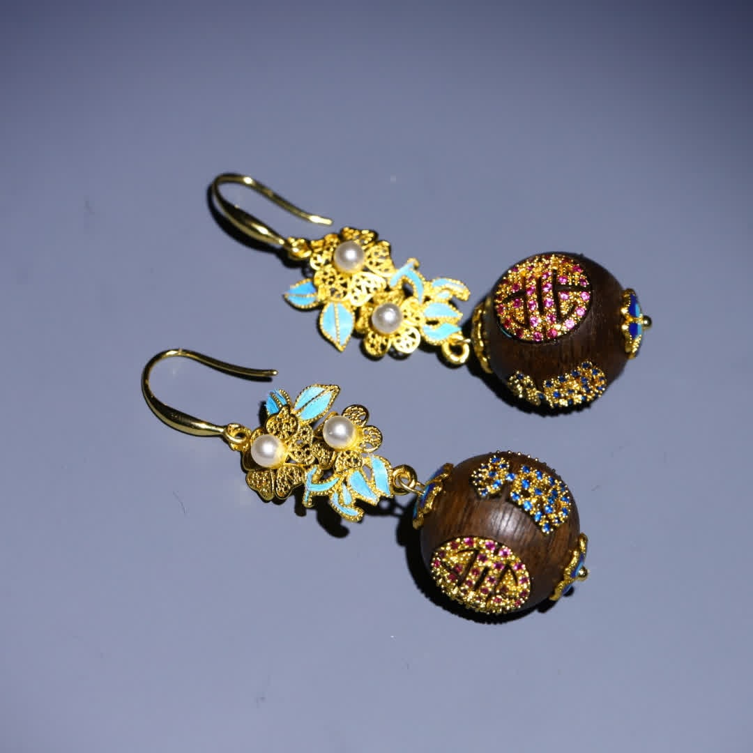 A pair of Qing Dynasty agarwood inlaid silver gilt round longevity pattern earrings: A pair of Qing dynasty agarwood earrings inlaid with silver gilt Tuanshou pattern SIZE: L: 6.5cm Agarwood bead diameter 1.9cm W: 14.9g (The Dimensions Of All Batches Are Manually Measured.If You Need