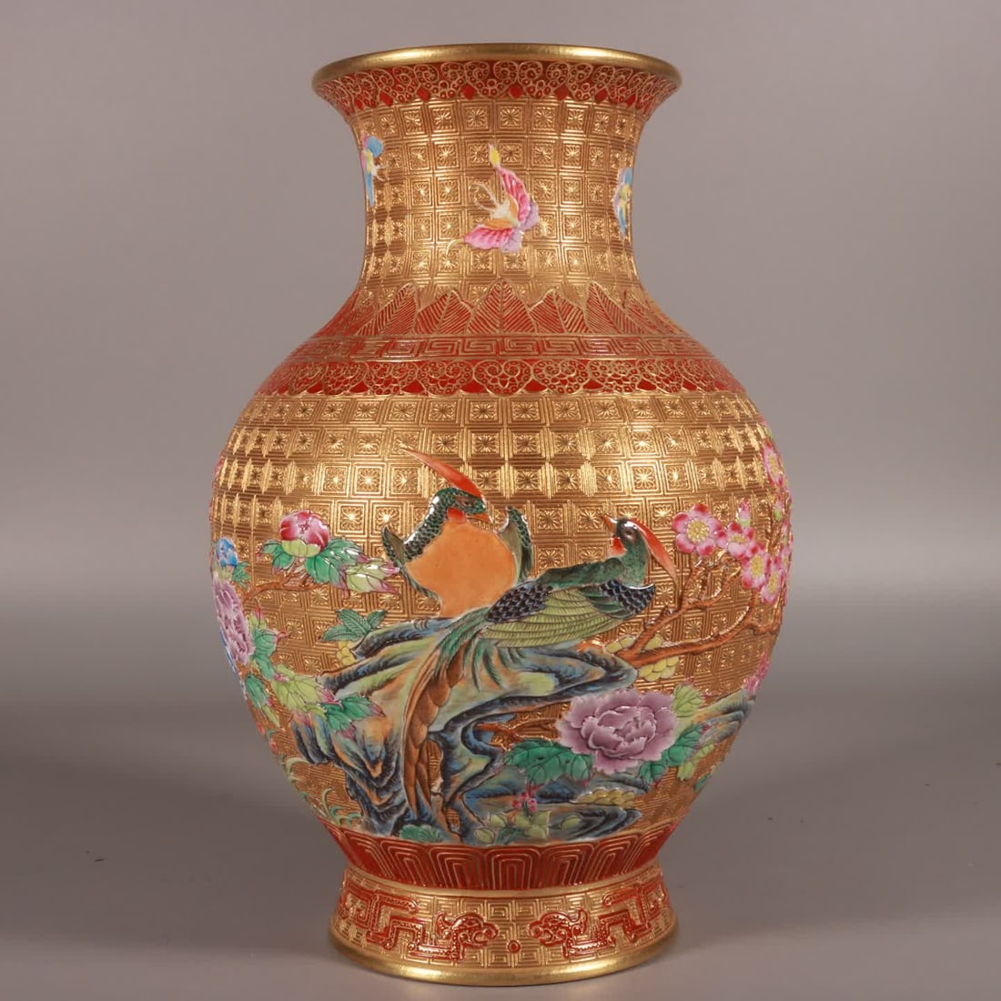 A Qing Qianlong period enamel and gold-ground flower-and-bird vase carved with enamel colors (1 of 9)