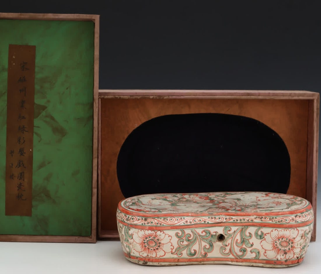 A Song dynasty porcelain pillow from Zhou Kiln with red and green painted infant play scenes (1 of 9)