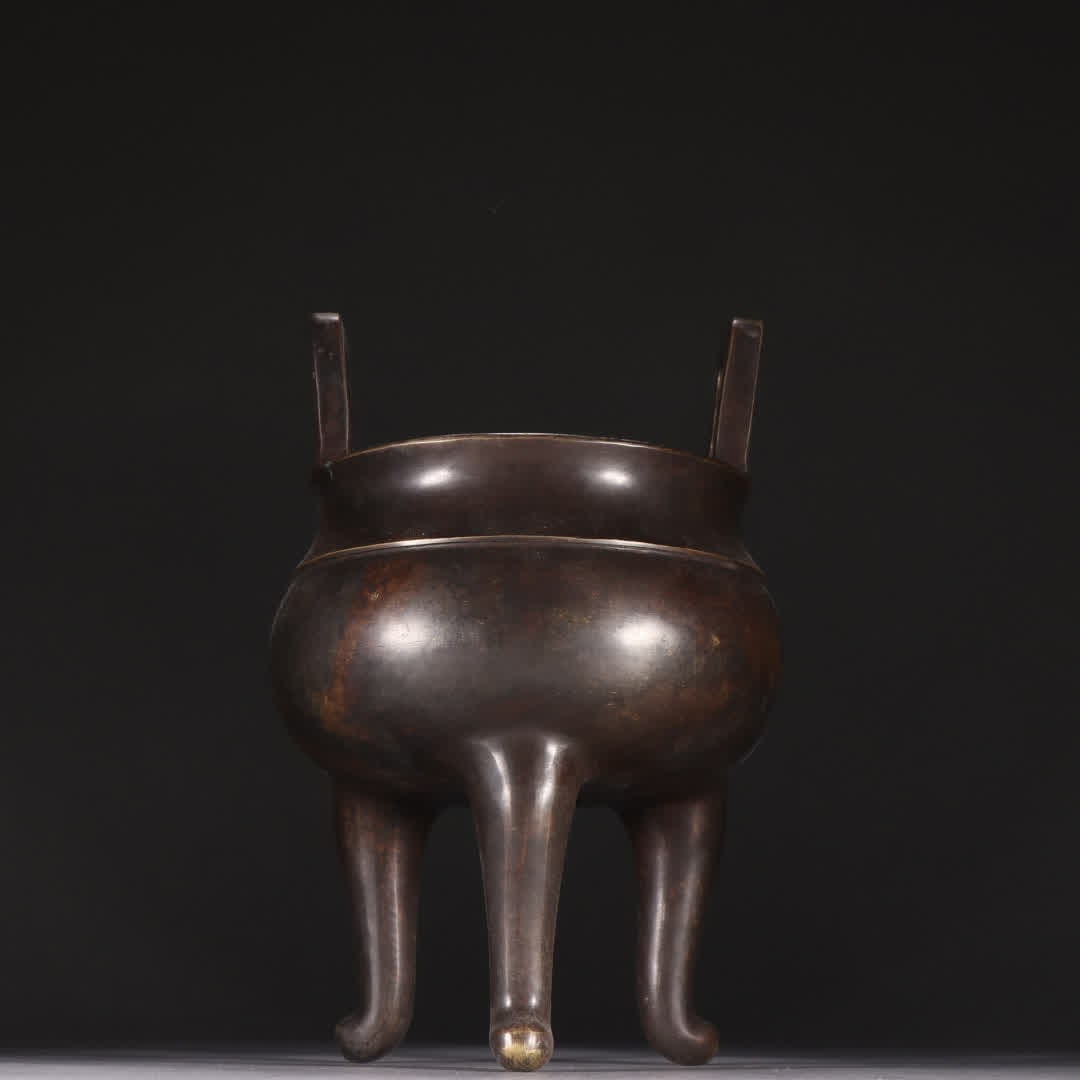 A Qing dynasty bronze three-legged incense burner (1 of 9)