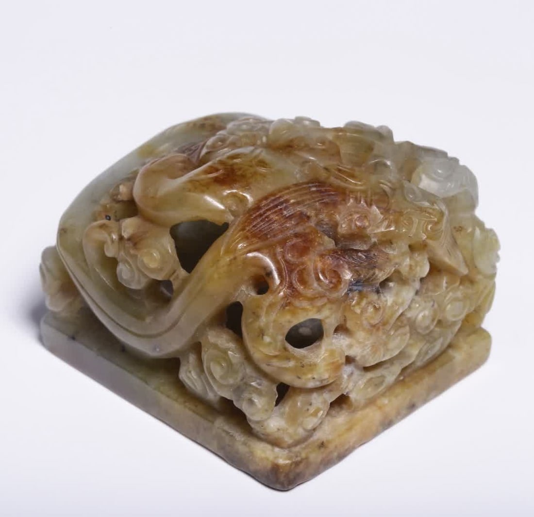 A Ming dynasty Hetian jade belt seal with a transparent carved cloud and dragon pattern (1 of 9)