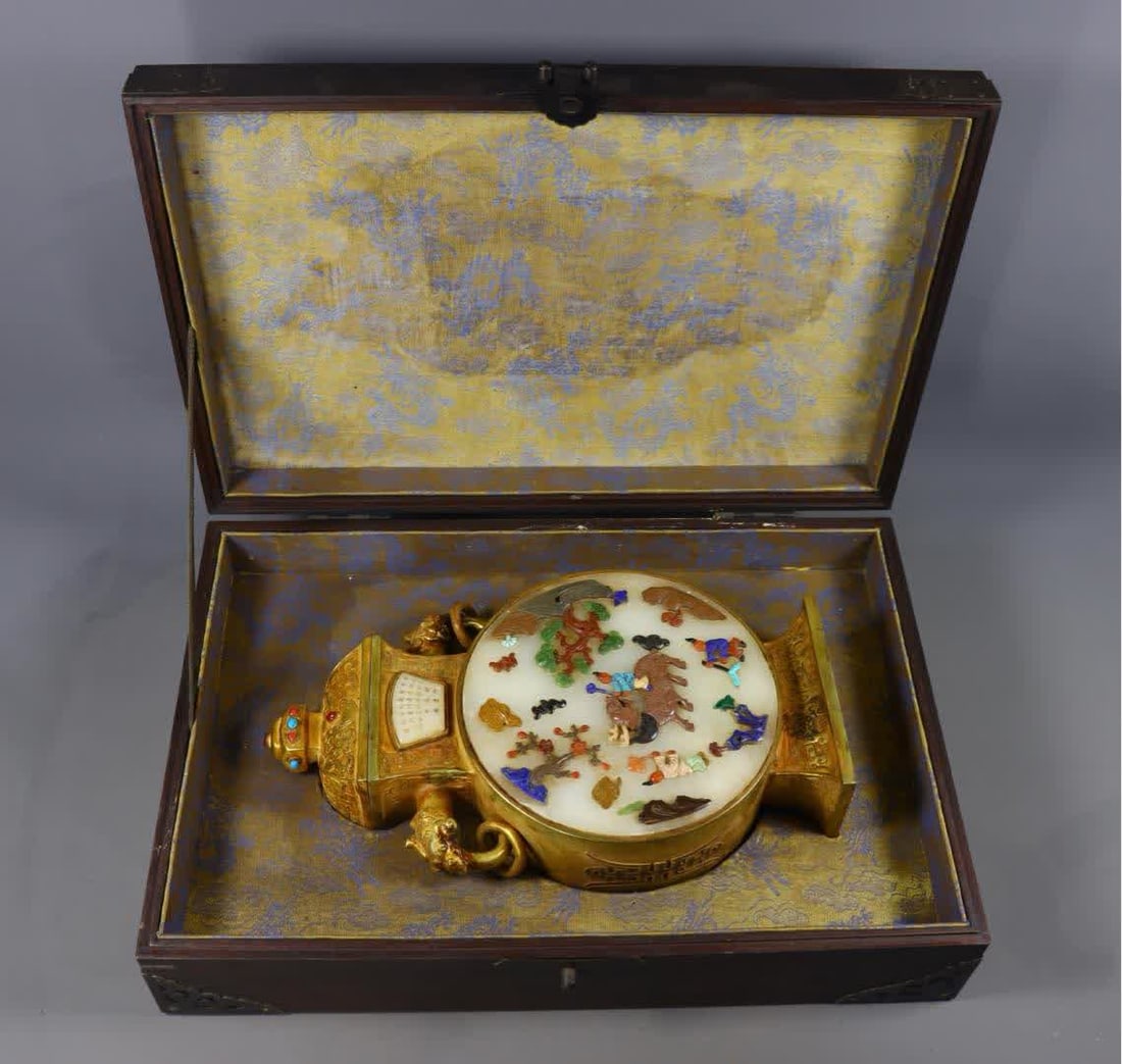 A Qing Dynasty copper gilded Hetian jade double-handled vase inlaid with eight treasures inlay: Qing Dynasty copper gilded Hetian jade double-handled vase with eight-treasure inlay craftsmanship SIZE: H:31.5cm L:17.5cm W:7.5cm W:2819g (The Dimensions Of All Batches Are Manually Measured.If You N