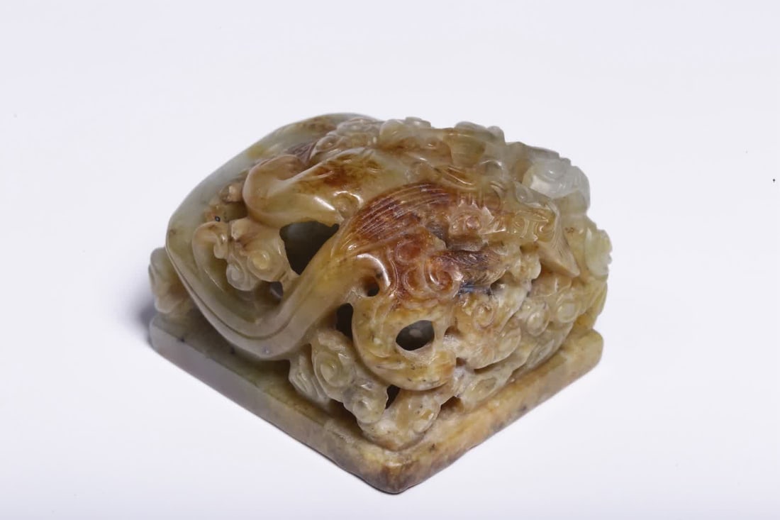 A pre-Ming dynasty Hetian jade belt seal with a translucent carved cloud and dragon pattern (1 of 9)