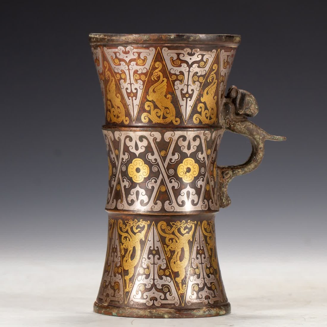 A Han Dynasty cup inlaid with gold and silver: Han dynasty cups inlaid with gold and silver SIZE: L:11cm W:8.5cm H:15.5cm W:640g (The Dimensions Of All Batches Are Manually Measured.If You Need More Detailed Information, Please Contact Our Custome