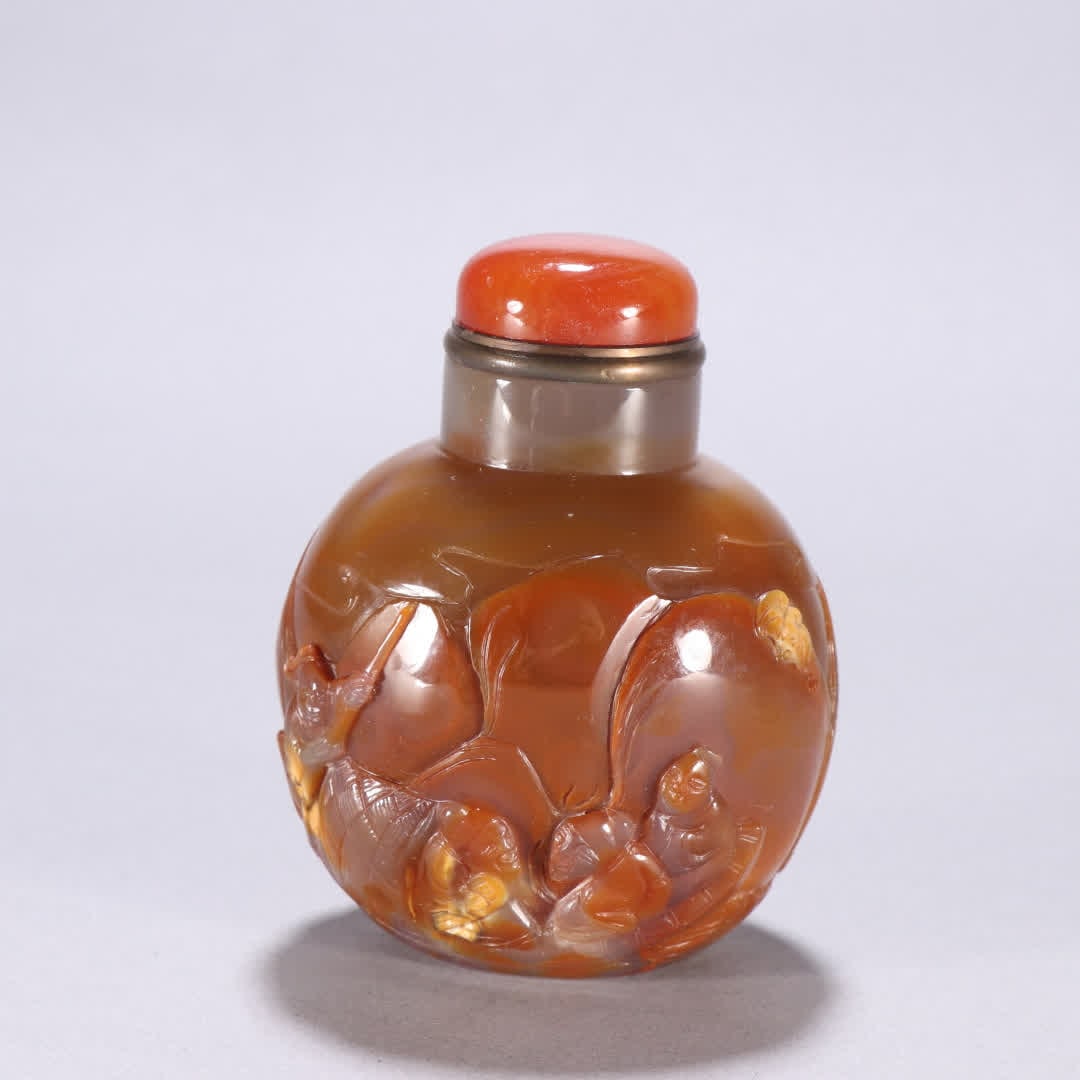A snuff bottle made of agate with gold intricately carved figures, stories, poetry, and prose (1 of 9)