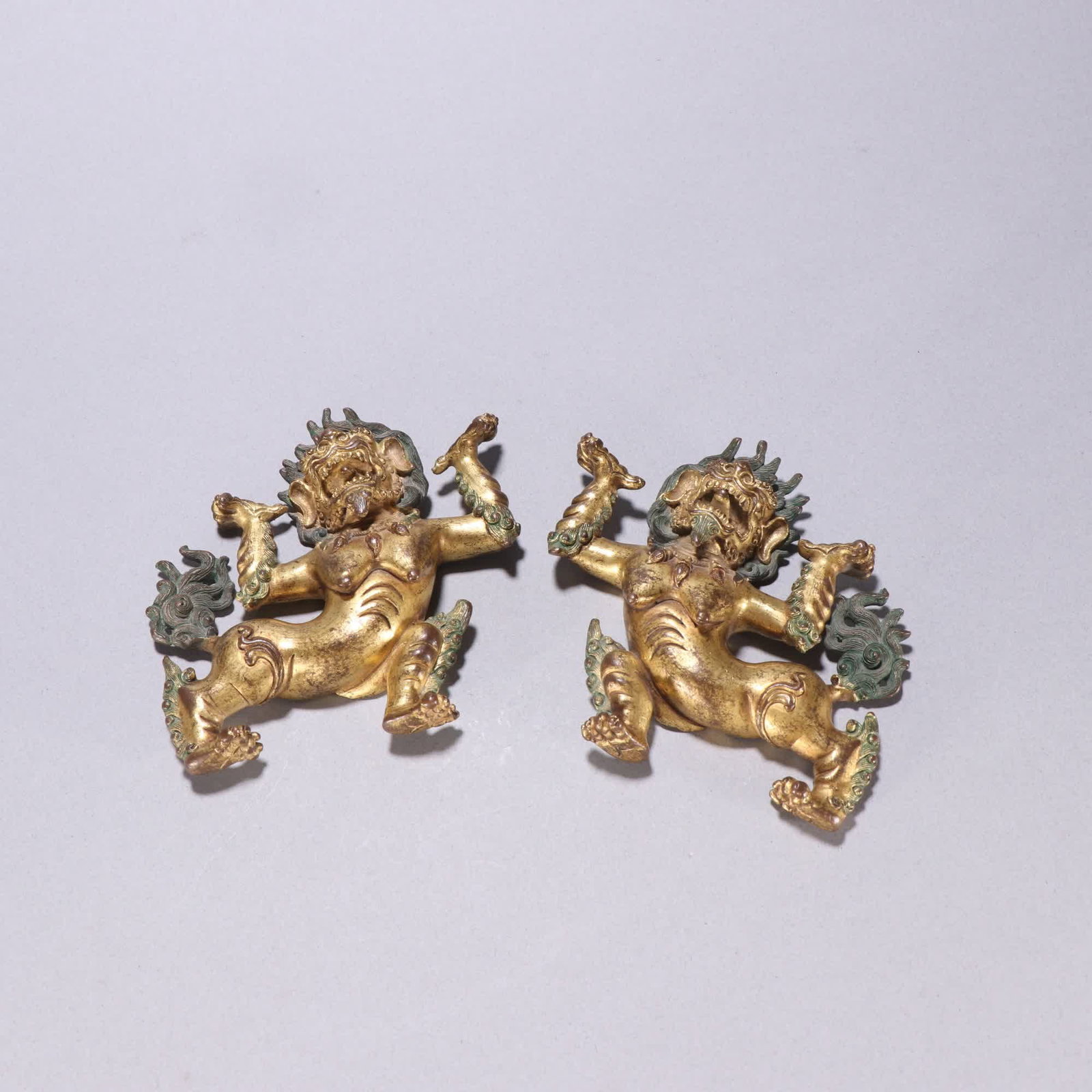 A Qing Dynasty gilt bronze snow lion: Qing Dynasty: A pair of gilt bronze snow lions SIZE: H:9.4cm W:9.6cm Total W:413.8g (The Dimensions Of All Batches Are Manually Measured.If You Need More Detailed Information, Please Contact Our