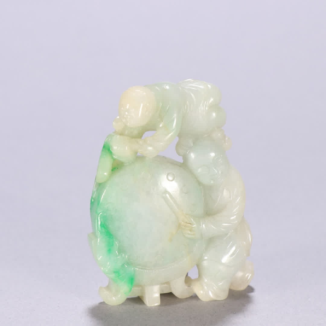 A Qing Dynasty jadeite "Boy Drumming" ornament: Qing Dynasty jadeite "Boy Drumming" ornament SIZE: H:6.3cm W:4.9cm W:80.7g (The Dimensions Of All Batches Are Manually Measured.If You Need More Detailed Information, Please Contact Our Customer Servi