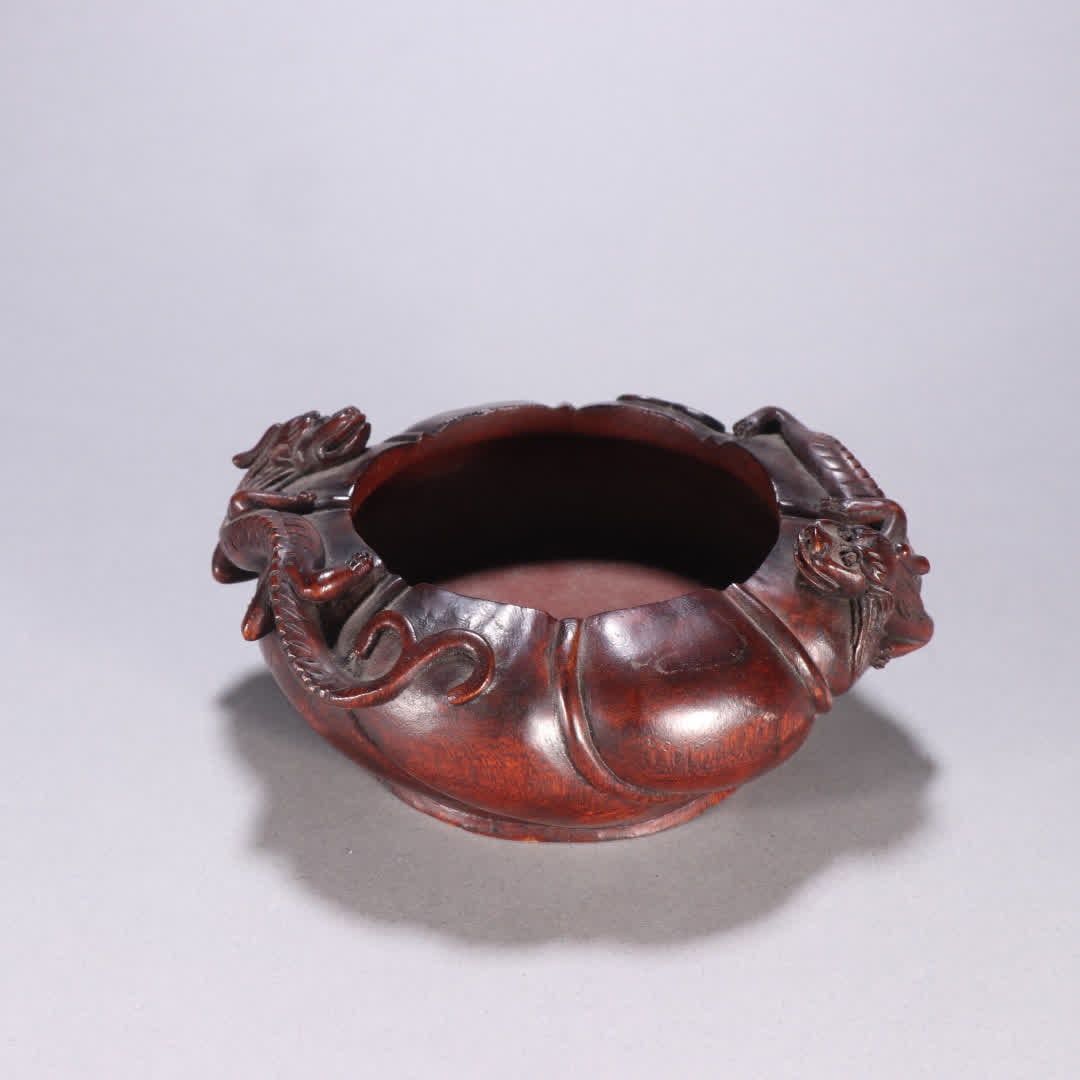 One is a water basin with agarwood chi dragon pattern: Agarwood Chi Dragon Pattern Water Basin SIZE: H:5.5cm W:15cm W:100g (The Dimensions Of All Batches Are Manually Measured.If You Need More Detailed Information, Please Contact Our Customer Service Befo