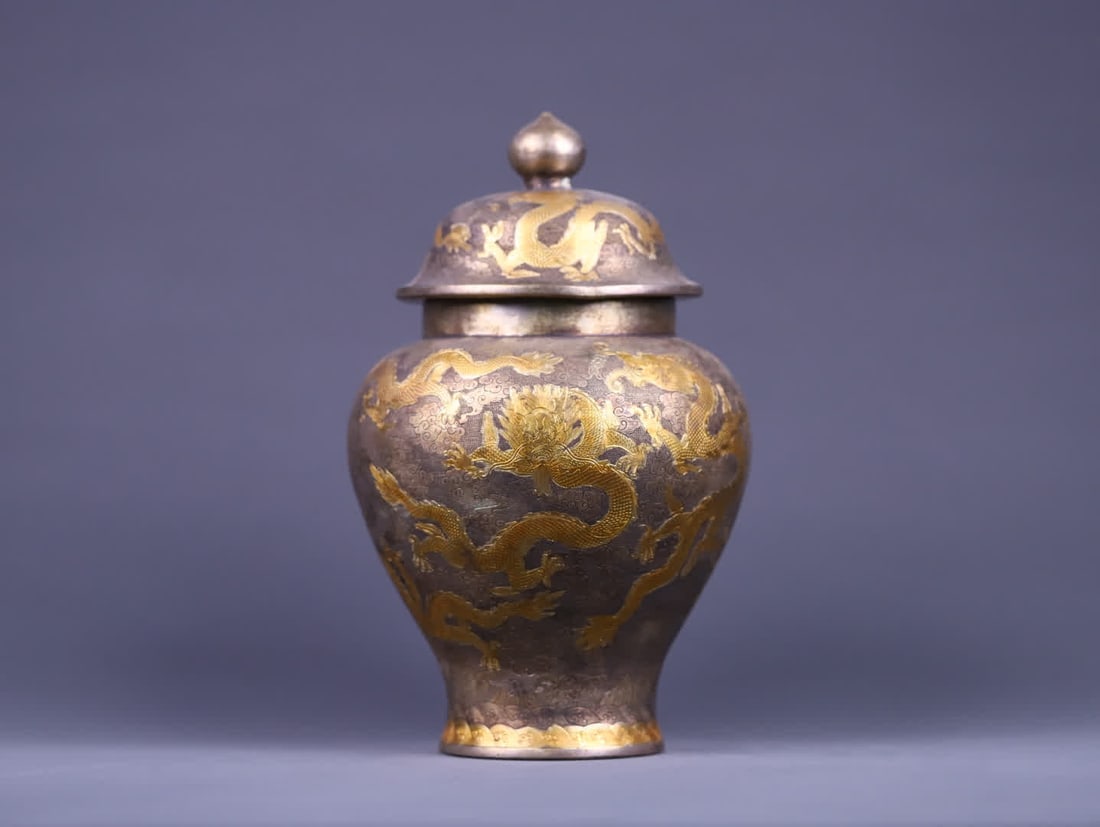 A pre-Ming dynasty gilded general's jar with cloud and dragon patterns: Before the Ming Dynasty, the gilded cloud and dragon pattern general jar had a heavy body, with a surface of fine pearl base. Using engraving and gilding techniques, it vividly presented the five-claw