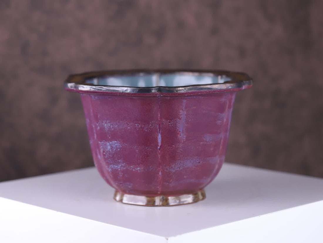 A Song Dynasty Jun kiln six-petal flowerpot: Song Dynasty Jun Kiln Six-Petal Flowerpot Imperial Display Vessel for the Song Dynasty Imperial Court. The pot is shaped like a six-petal flower mouth, with a bulging belly and ring feet, elegant and 