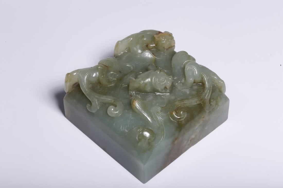 A pre-Ming dynasty Hetian jade seal with a chi dragon knob (1 of 10)