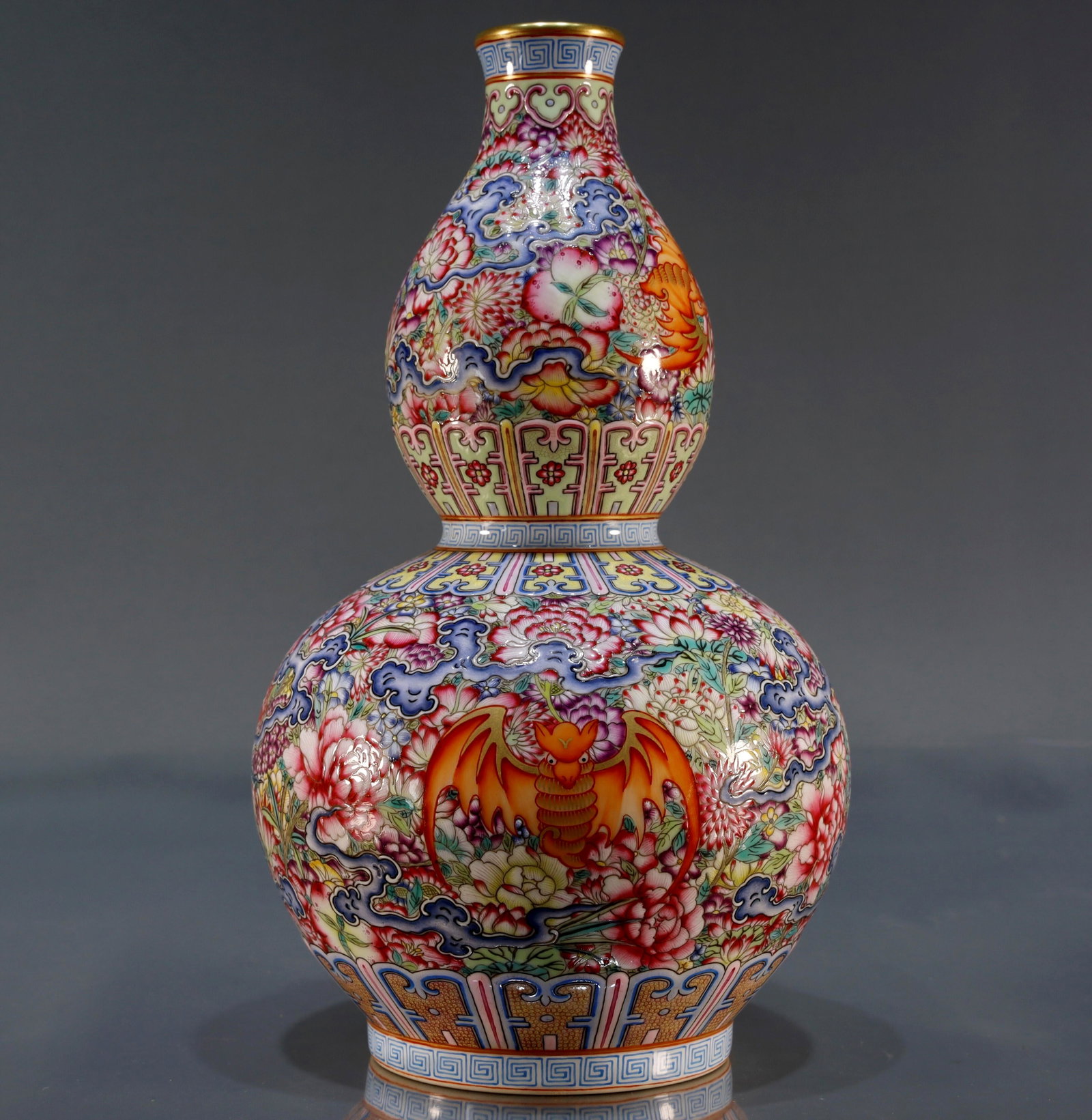 A famille rose gourd vase with floral bat design: A famille rose gourd vase with floral bat design. Qianlong Six-Character Mark. Size:15cmx25cm