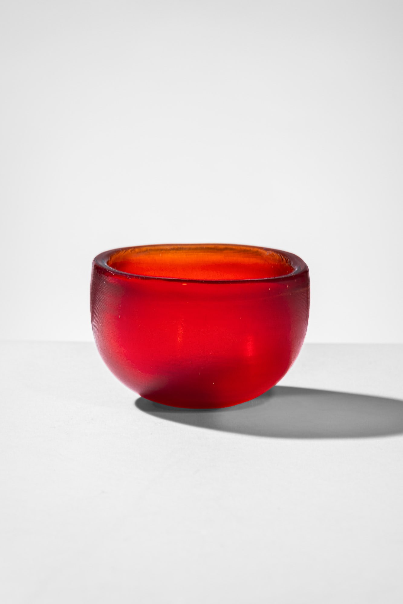 Paolo Venini. Coppa della serie Incisi: Coppa della serie Incisi Vetro pesante rosso, a colori sovrapposti, rifinito da leggere incisioni orizzontali su tutta la superficie. Venini, 1956 Firma all'acido Venini Murano Italia. cm 7x11x11 Bibi