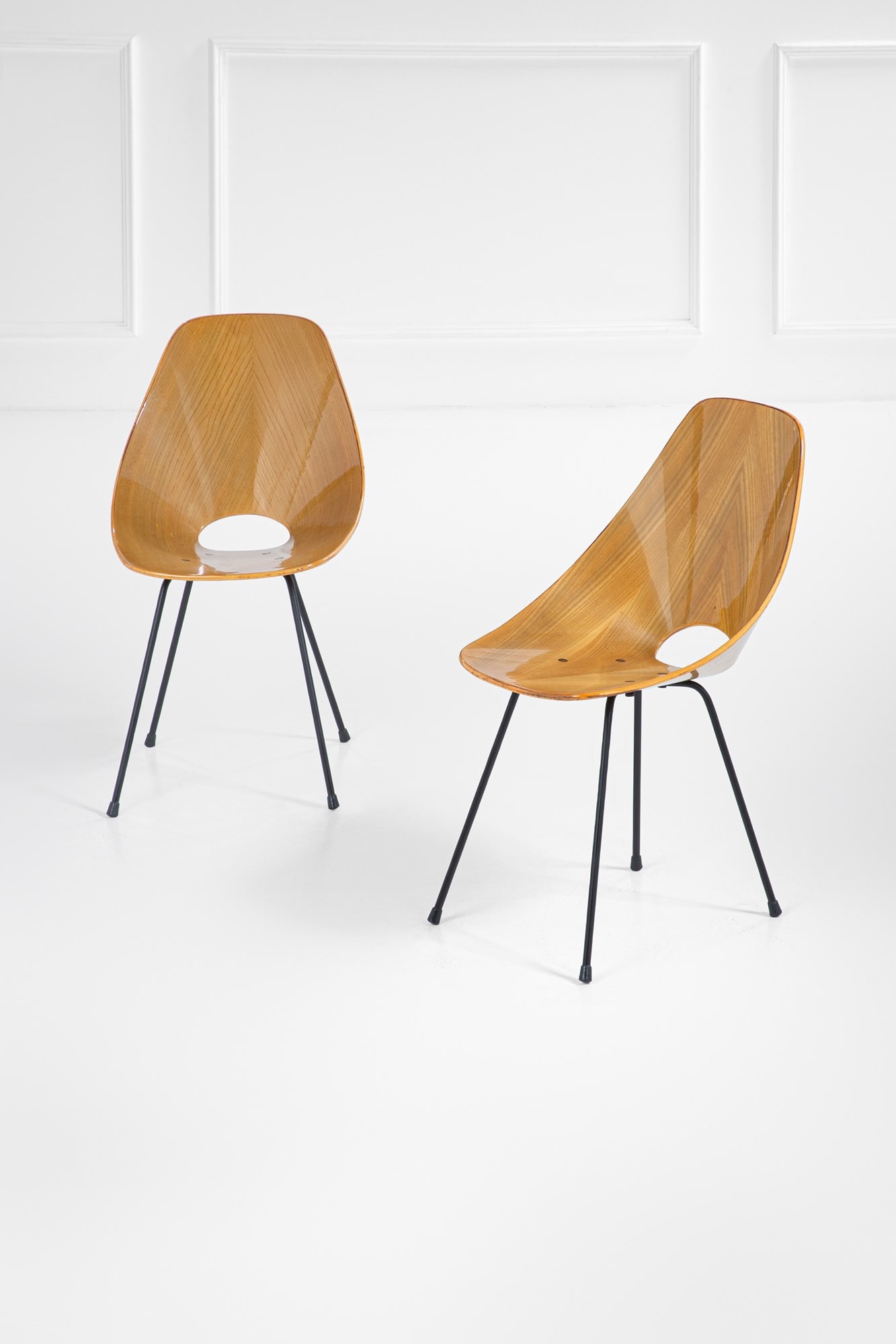 Vittorio Nobili. Due sedie mod. 101 della serie Medea: Due sedie mod. 101 della serie MedeaLegno multistrato curvato, metallo verniciato.Prod. Fratelli Tagliabue, 1950 ca.Marchio a fuoco.cm 87x47x50BIBLIOGRAFIA: Domus, n. 329, aprile 1957, pubblicità;