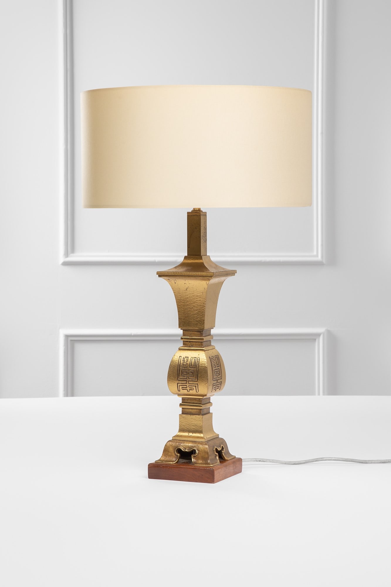 Luciano Frigerio. Lampada da tavolo mod. Jeanette: Lampada da tavolo mod. Jeanette Fusione di bronzo dorato con decoro inciso, legno, tessuto. Edizione Frigerio di Desio, 1970 ca. Certificato di autenticità. h cm 74,5, diam. paralume cm 40