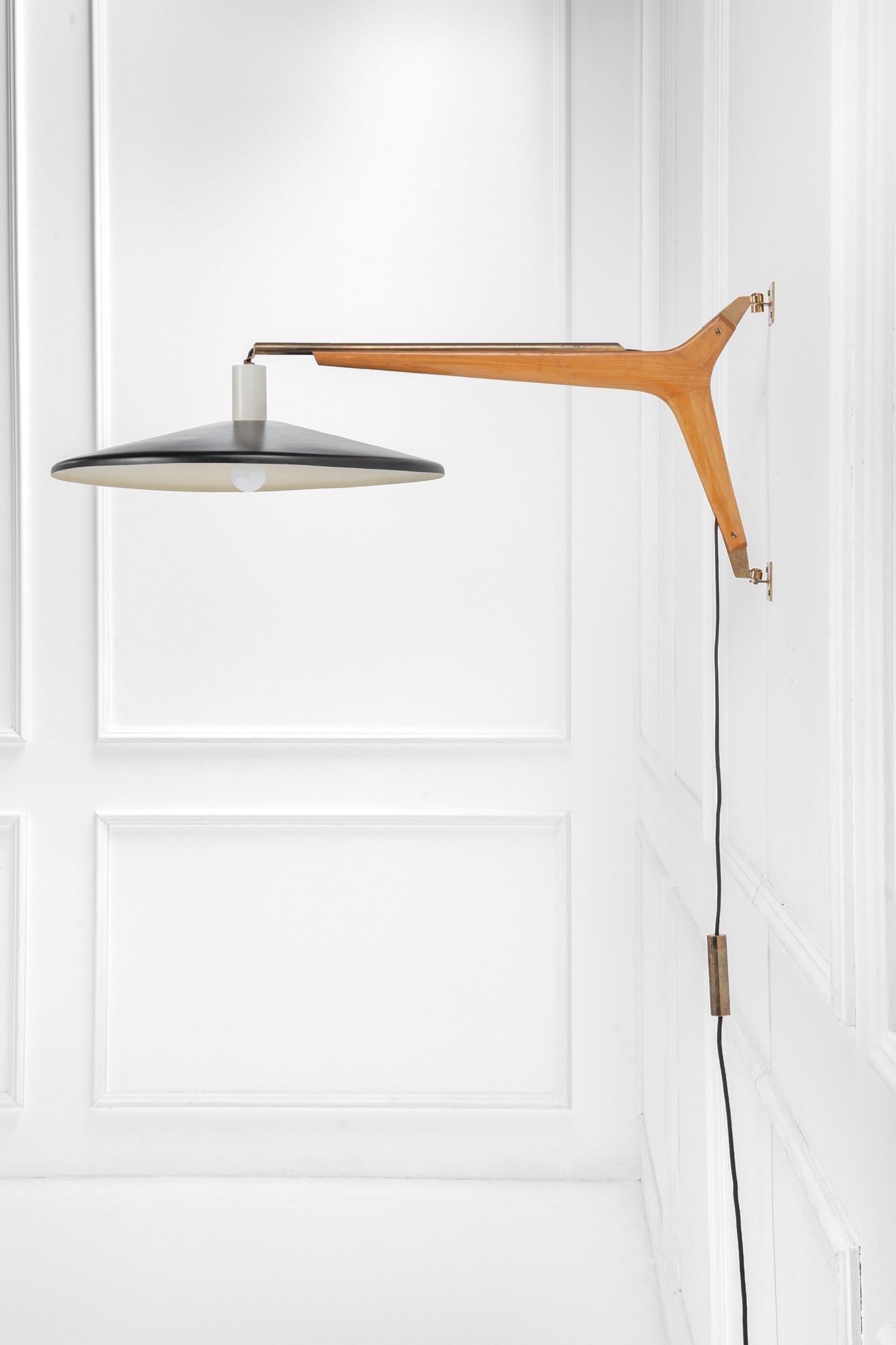 Stilnovo. Lampada da parete con saliscendi: Lampada da parete con saliscendiOttone, metallo verniciato, legno massello sagomato.Prod. Stilnovo, 1950 ca.Etichetta del produttore.lungh. braccio cm 65, diam. riflettore cm 48