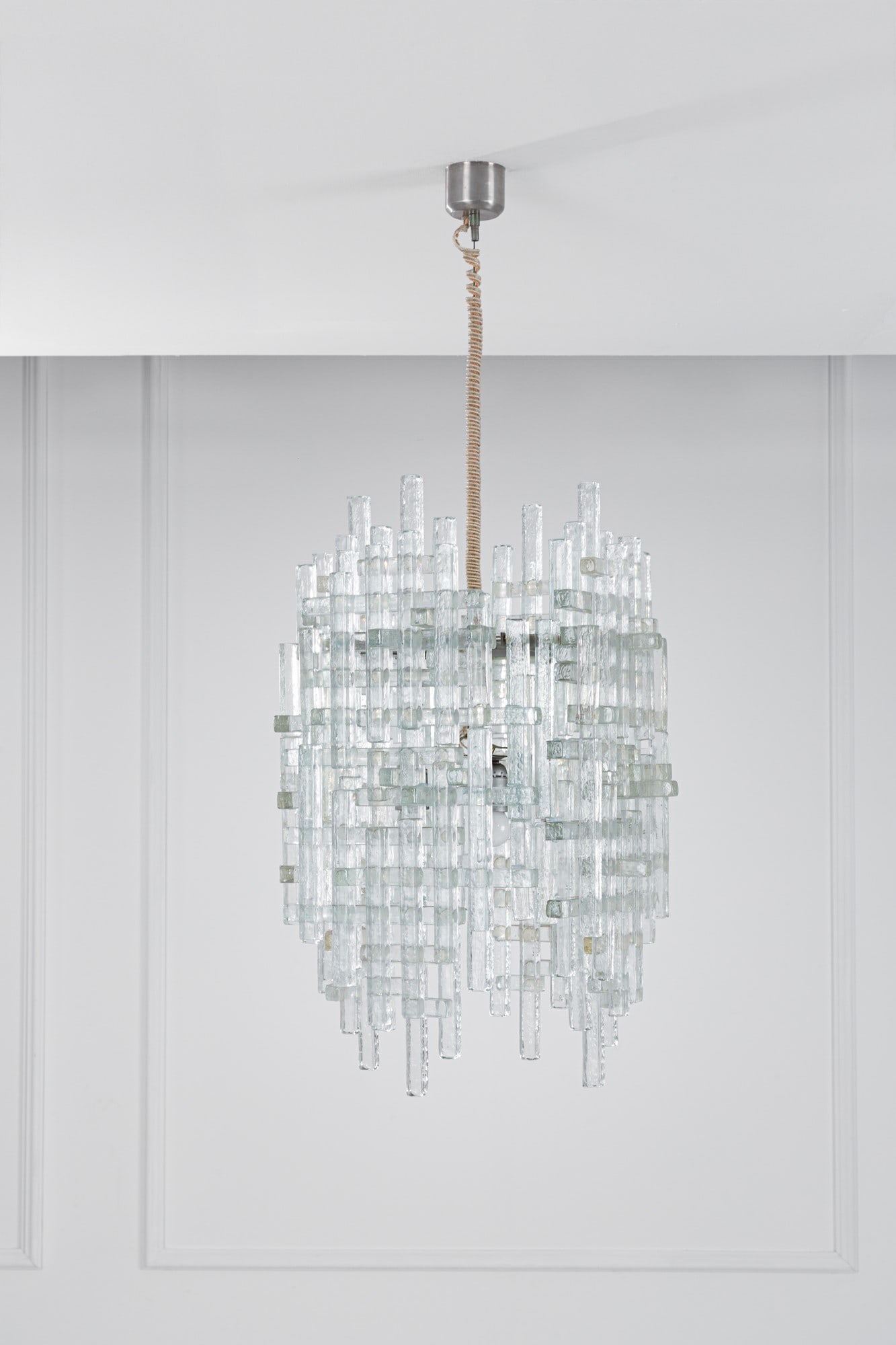 Albano Poli. Lampada a sospensione mod. Draco: Lampada a sospensione mod. Draco Elementi in vetro di forte spessore trasparente a superficie irregolare assemblati ad incastro. Prod. Poliarte, 1970 ca. cm 103x48x48 Bibliografia: Catalogo di produzi