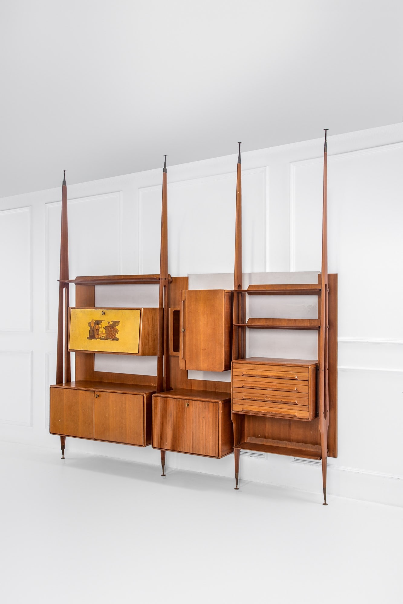 Galleria Mobili d'Arte Cantù. Libreria cielo-terra a tre campate: Libreria cielo-terra a tre campate Legno impiallacciato, legno massello sagomato, cristallo molato, vetro specchiato, ottone, anta con intarsio decorativo. Prod. Galleria Mobili d'Arte Cantù, 1950 ca