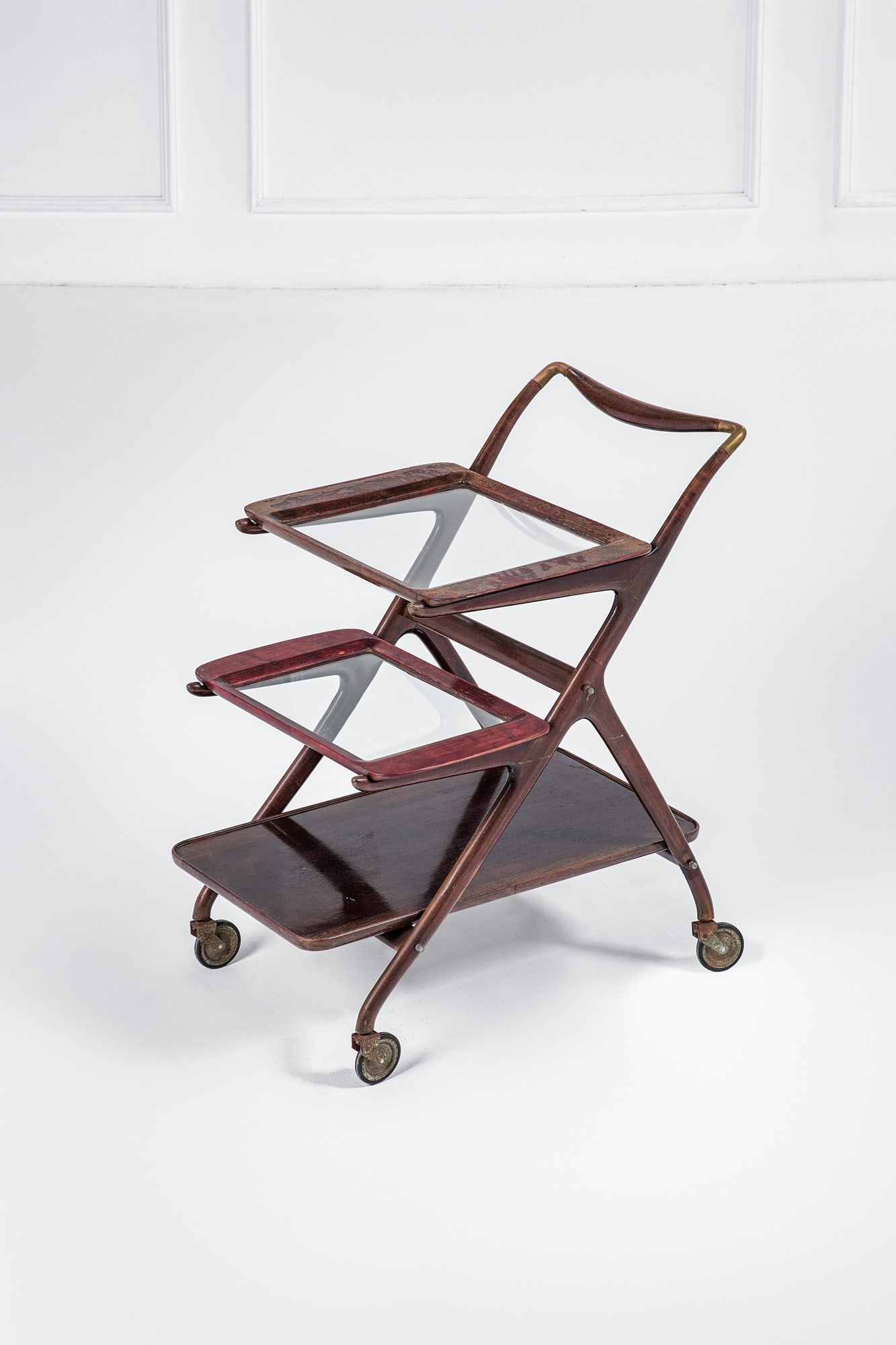 Ico Parisi. Carrello con vassoi asportabili mod. 65: Carrello con vassoi asportabili mod. 65 Legno sagomato tinto, cristallo, ottone. Prod. De Baggis, 1956 ca. Etichetta del produttore. cm 87x73x56 Bibliografia: R. Lietti, Ico Parisi. Design. Catalogo r