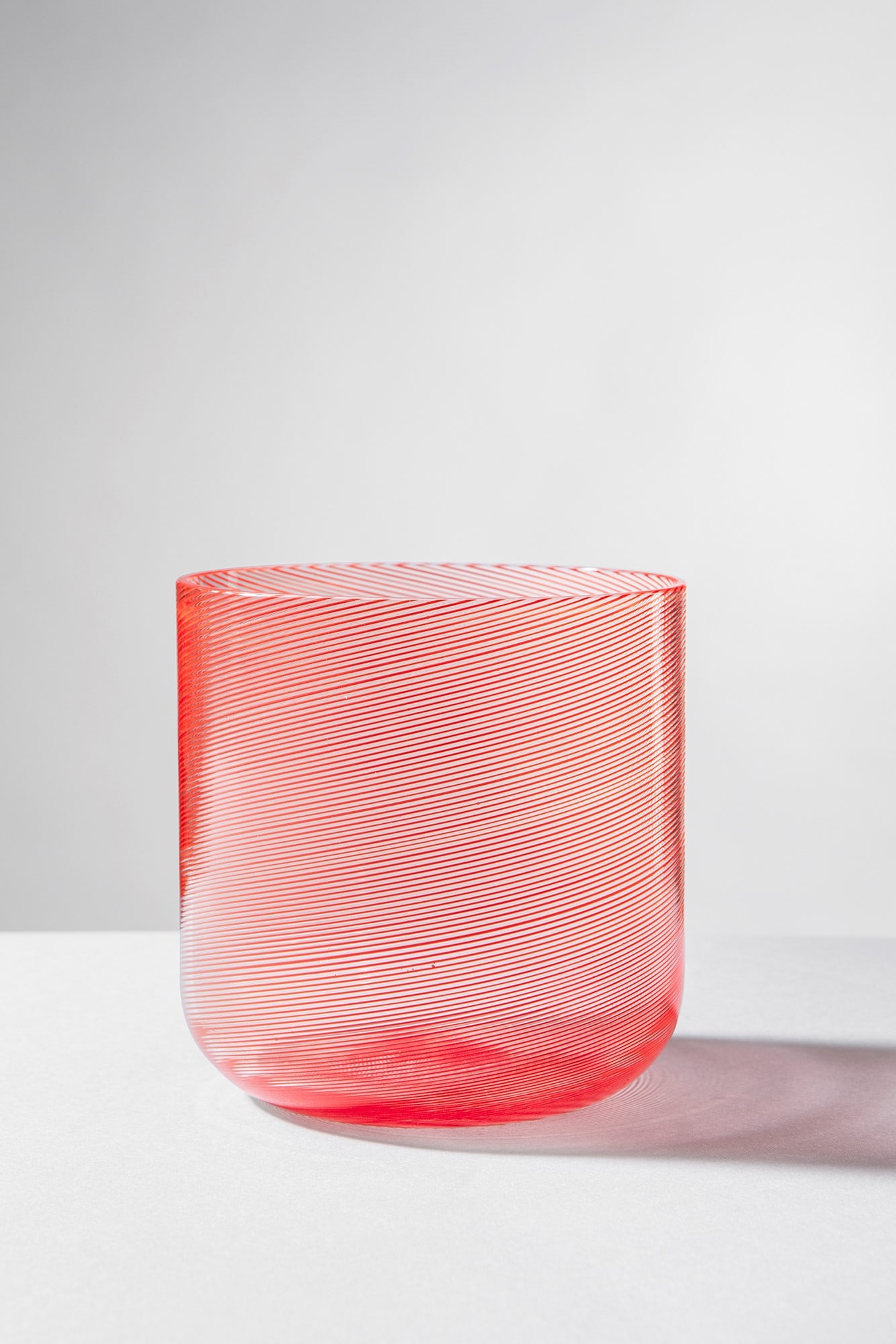 Carlo Scarpa. Vaso a mezza filigrana: Vaso a mezza filigrana Vetro trasparente soffiato a mezza filigrana corallo. Venini, 1965 ca. Firma incisa a punta Venini Italia. h cm 11, diam. cm 11 Bibliografia: Marino Brovier, Carlo Scarpa